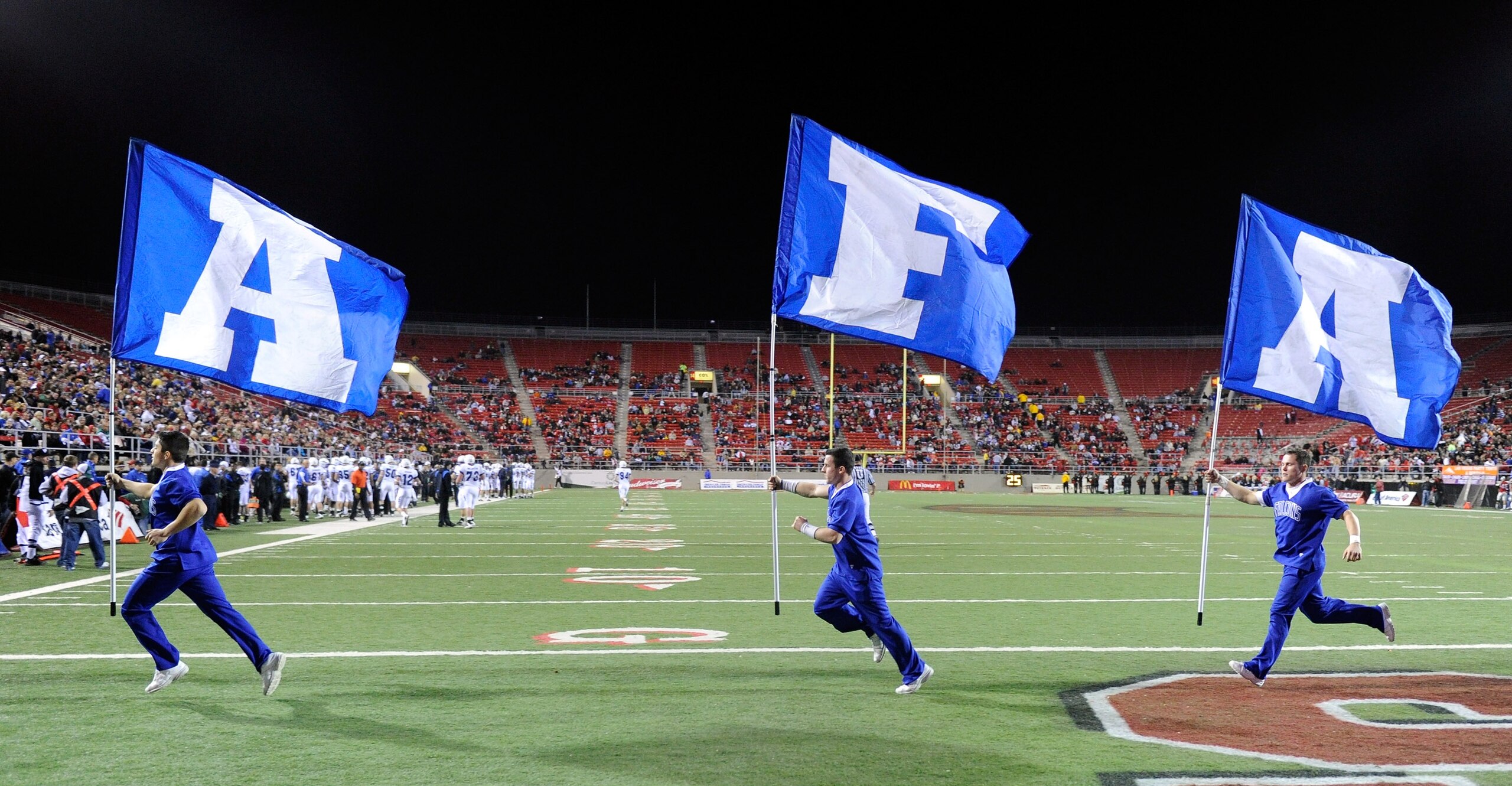 LAS VEGAS - NOVEMBER 18:  Air Force Falcons cheerleaders run flags through the end zone after an Air Force touchdown against the UNLV Rebels at Sam Boyd Stadium November 18, 2010 in Las Vegas, Nevada. Air Force won 35-20.  (Photo by Ethan Miller/Getty Ima