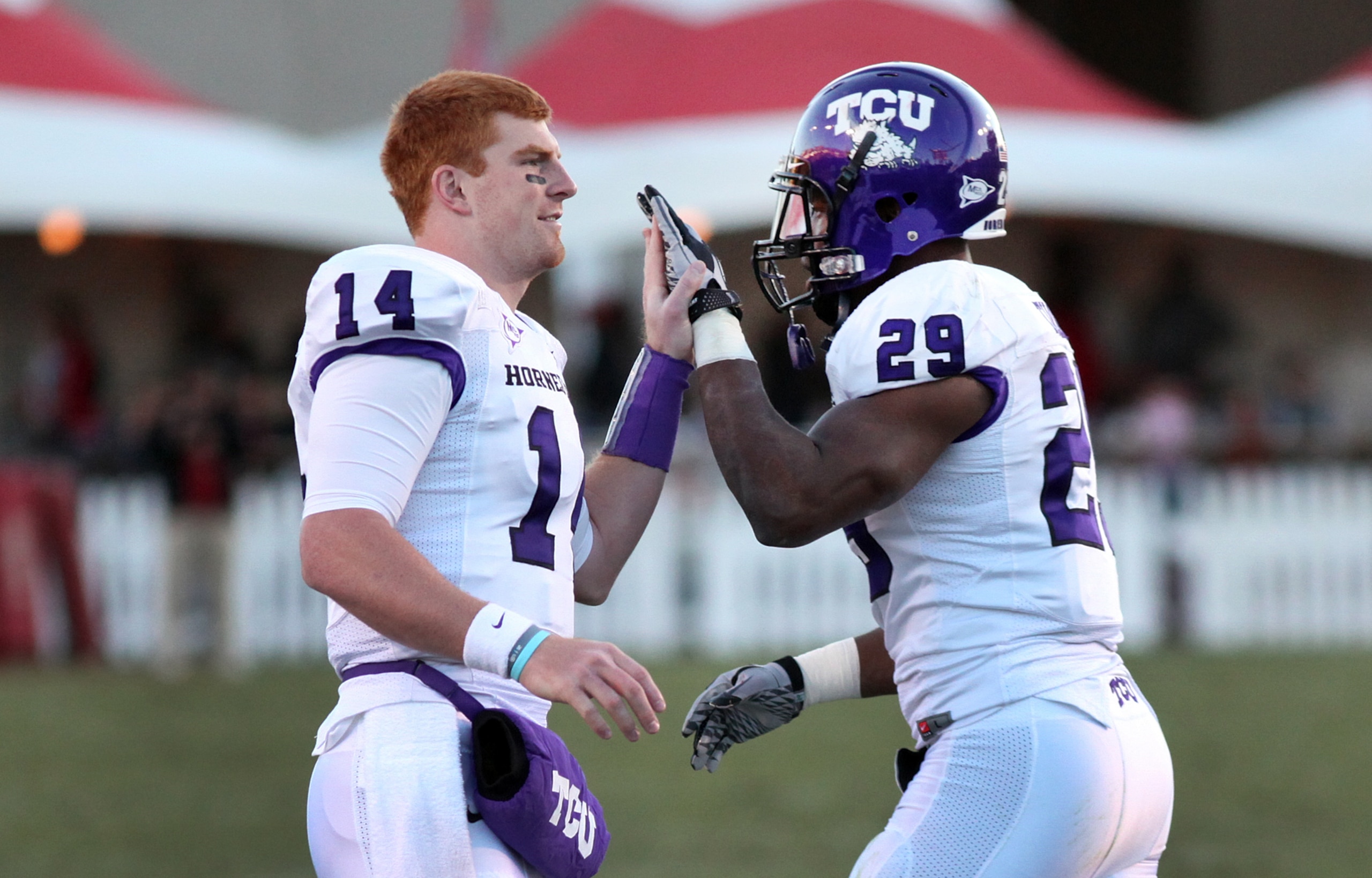 ALBUQUERQUE, NM - NOVEMBER 27: Quarterback Andy Dalton #14 of the TCU Horned Frogs celebrates with running back Matthew Tucker #29 against the University of New Mexico Lobos on November 27, 2010 at University Stadium in Albuquerque, New Mexico. TCU won 66
