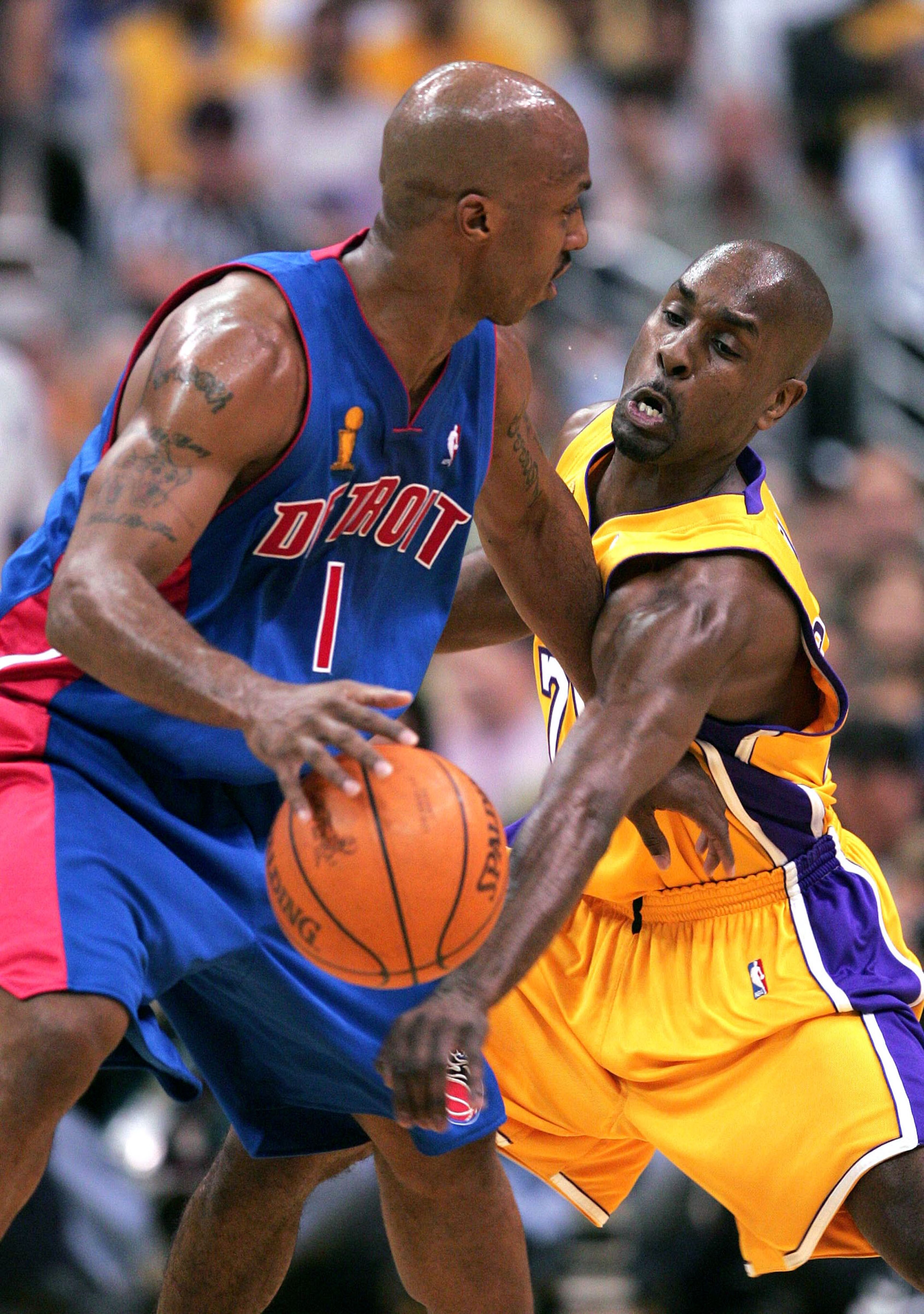 LOS ANGELES - JUNE 8:  Chauncey Billups #1 of the Detroit Pistons looks to pass under pressure from Gary Payton #20 of the Los Angeles Lakers in the first half of Game 2 of the 2004 NBA Finals on June 8, 2004 at Staples Center in Los Angeles, California.