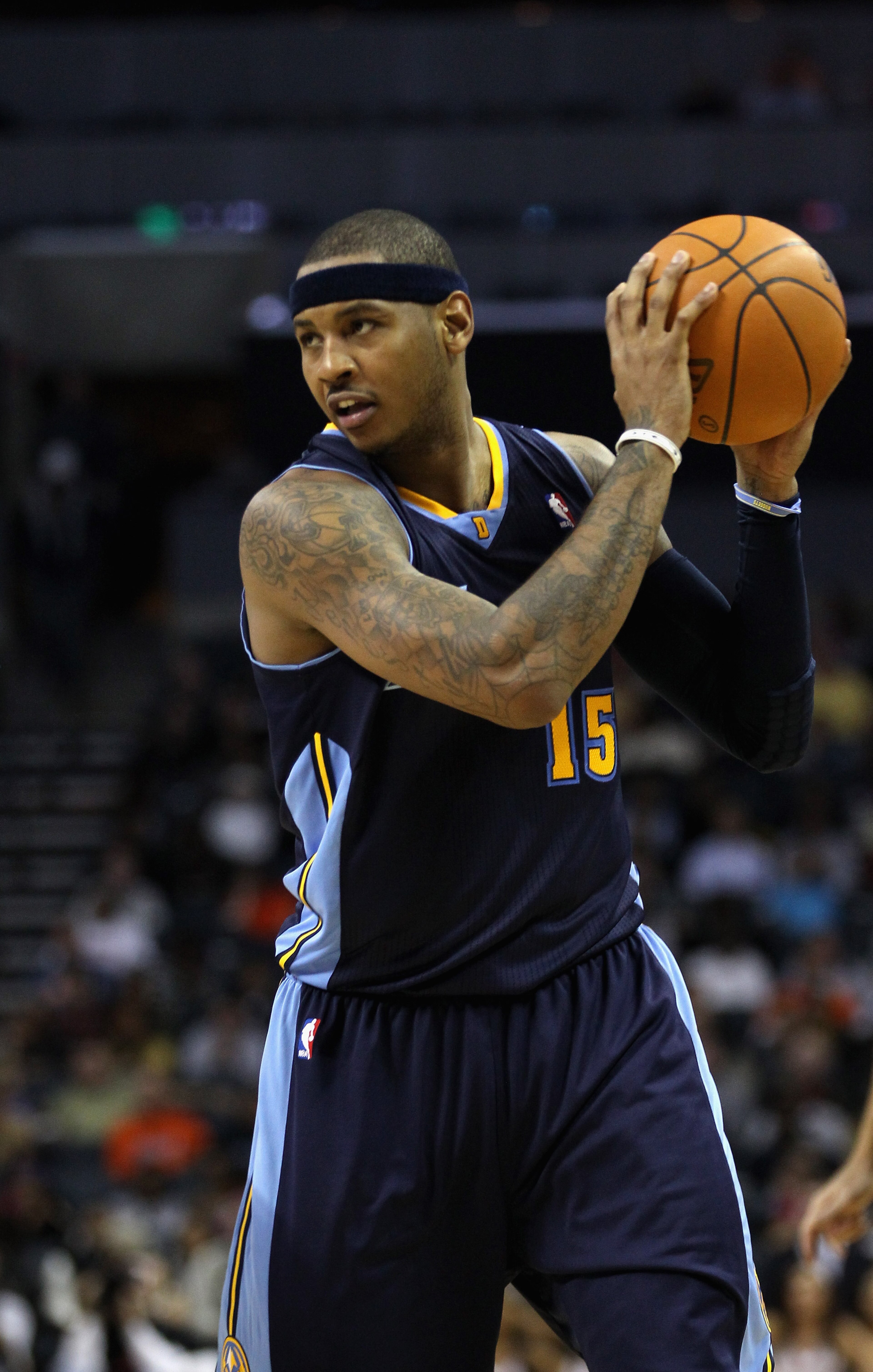 CHARLOTTE, NC - DECEMBER 07: Carmelo Anthony #15 of the Denver Nuggets watches on against the Charlotte Bobcats during their game at Time Warner Cable Arena on December 7, 2010 in Charlotte, North Carolina. NOTE TO USER: User expressly acknowledges and CHARLOTTE, NC - DECEMBER 07: Carmelo Anthony #15 of the Denver Nuggets watches on against the Charlotte Bobcats during their game at Time Warner Cable Arena on December 7, 2010 in Charlotte, North Carolina. NOTE TO USER: User expressly acknowledges and