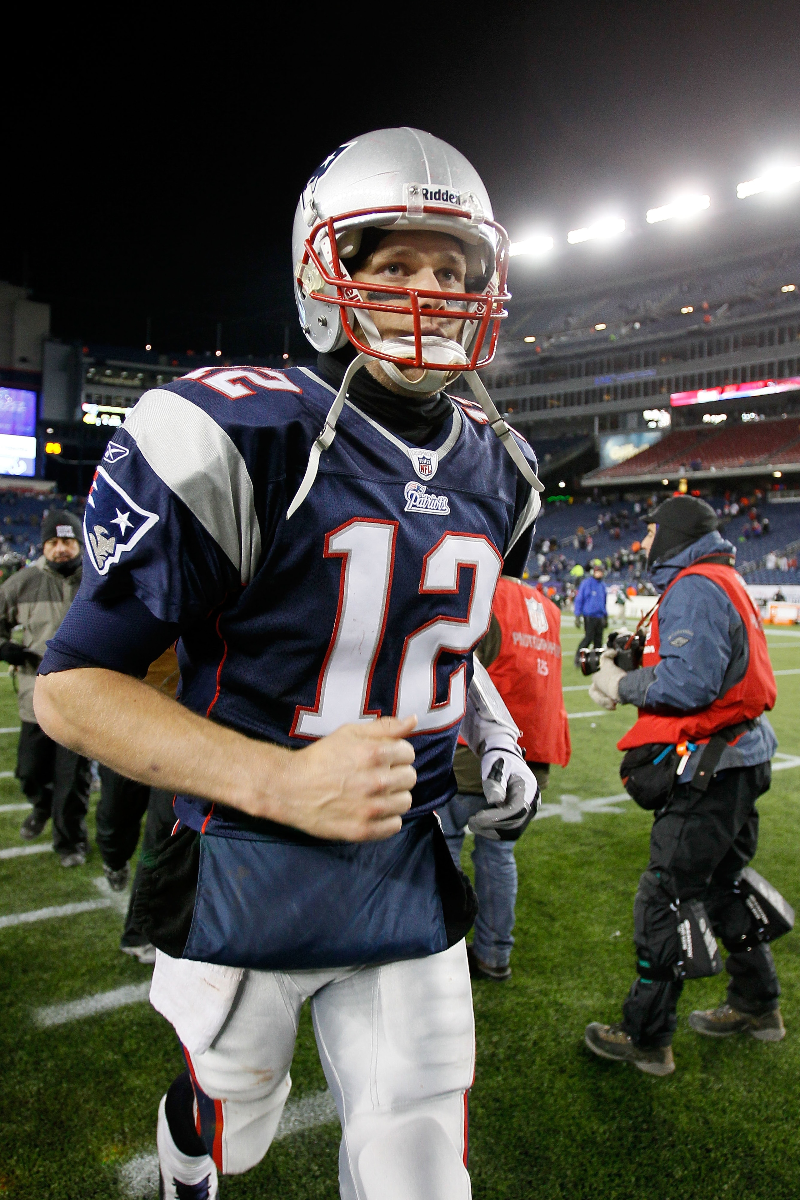 FOXBORO, MA - DECEMBER 06:  Tom Brady #12 of the New England Patriots runs off the field after the Patriots won 45-3 against the New York Jets at Gillette Stadium on December 6, 2010 in Foxboro, Massachusetts.  (Photo by Jim Rogash/Getty Images)