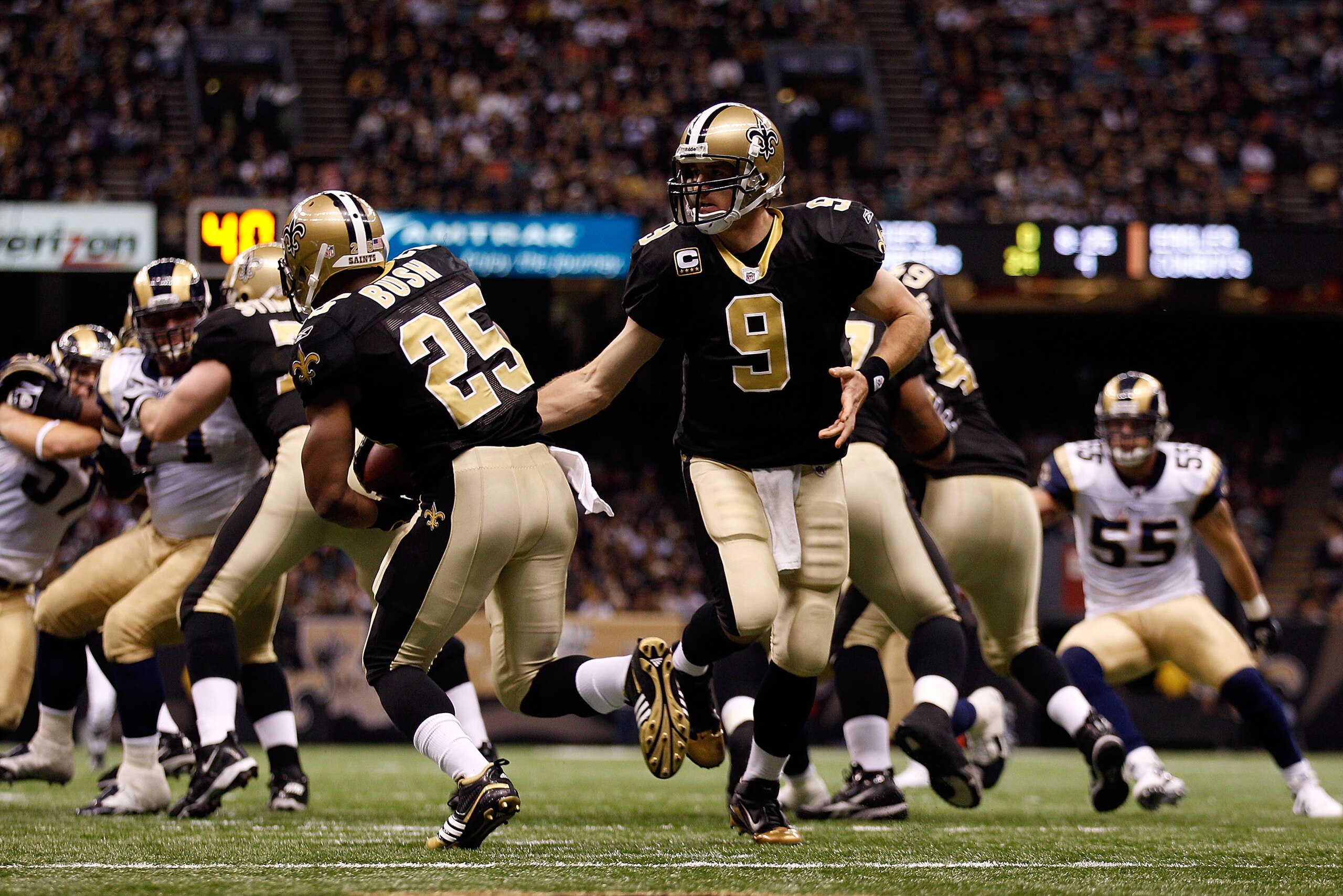 NEW ORLEANS, LA - DECEMBER 12:  Drew Brees #9 hands the ball off to Reggie Bush #25 of the New Orleans Saints during the game against the St. Louis Rams at the Louisiana Superdome on December 12, 2010 in New Orleans, Louisiana. The Saints defeated the Ram