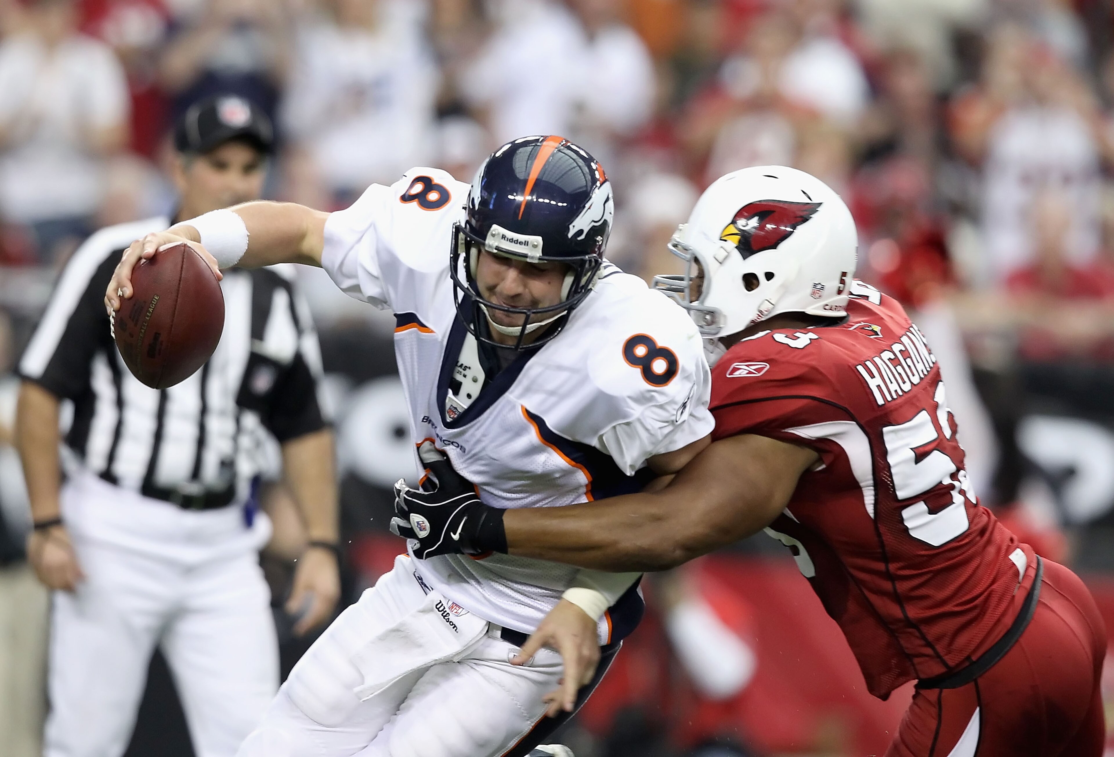 GLENDALE, AZ - DECEMBER 12: Quarterback Kyle Orton #8 of the Denver Broncos is sacked by Clark Haggans #53 of the Arizona Cardinals during the NFL game at the University of Phoenix Stadium on December 12, 2010 in Glendale, Arizona. The Cardinals defeate GLENDALE, AZ - DECEMBER 12: Quarterback Kyle Orton #8 of the Denver Broncos is sacked by Clark Haggans #53 of the Arizona Cardinals during the NFL game at the University of Phoenix Stadium on December 12, 2010 in Glendale, Arizona. The Cardinals defeate