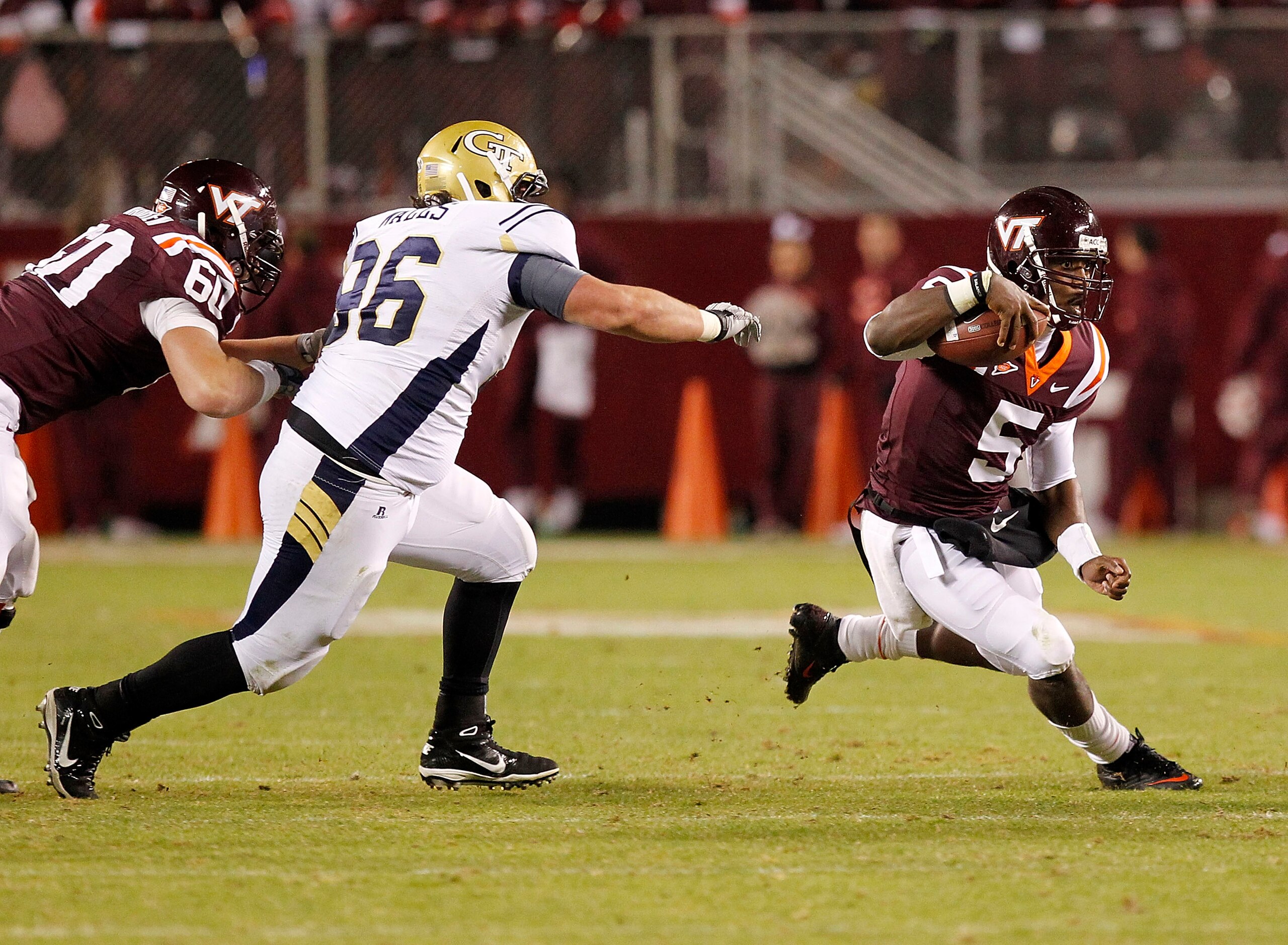 BLACKSBURG, VA - NOVEMBER 04: Quarterback Tyrod Taylor #5 of the Virginia Tech Hokies runs with the ball as defensive tackle Logan Walls #96 of the Georgia Tech Yellow Jackets chases at Lane Stadium on November 4, 2010 in Blacksburg, Virginia.  (Photo by