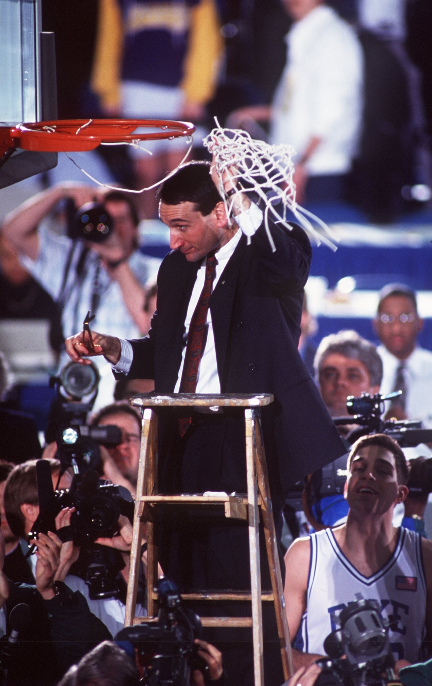 APR 1991:  MIKE KRZYZEWSKI, HEAD COACH OF DUKE BASKETBALL, CUTS DOWN THE NET AFTER WINNING THE NCAA NATIONAL CHAMPIONSHIP.   DUKE BEAT KANSAS 72-65 AT THE HOOSIER DOME, INDIANAPOLIS, INDIANA. Mandatory Credit: ALLSPORT USA/ALLSPORT