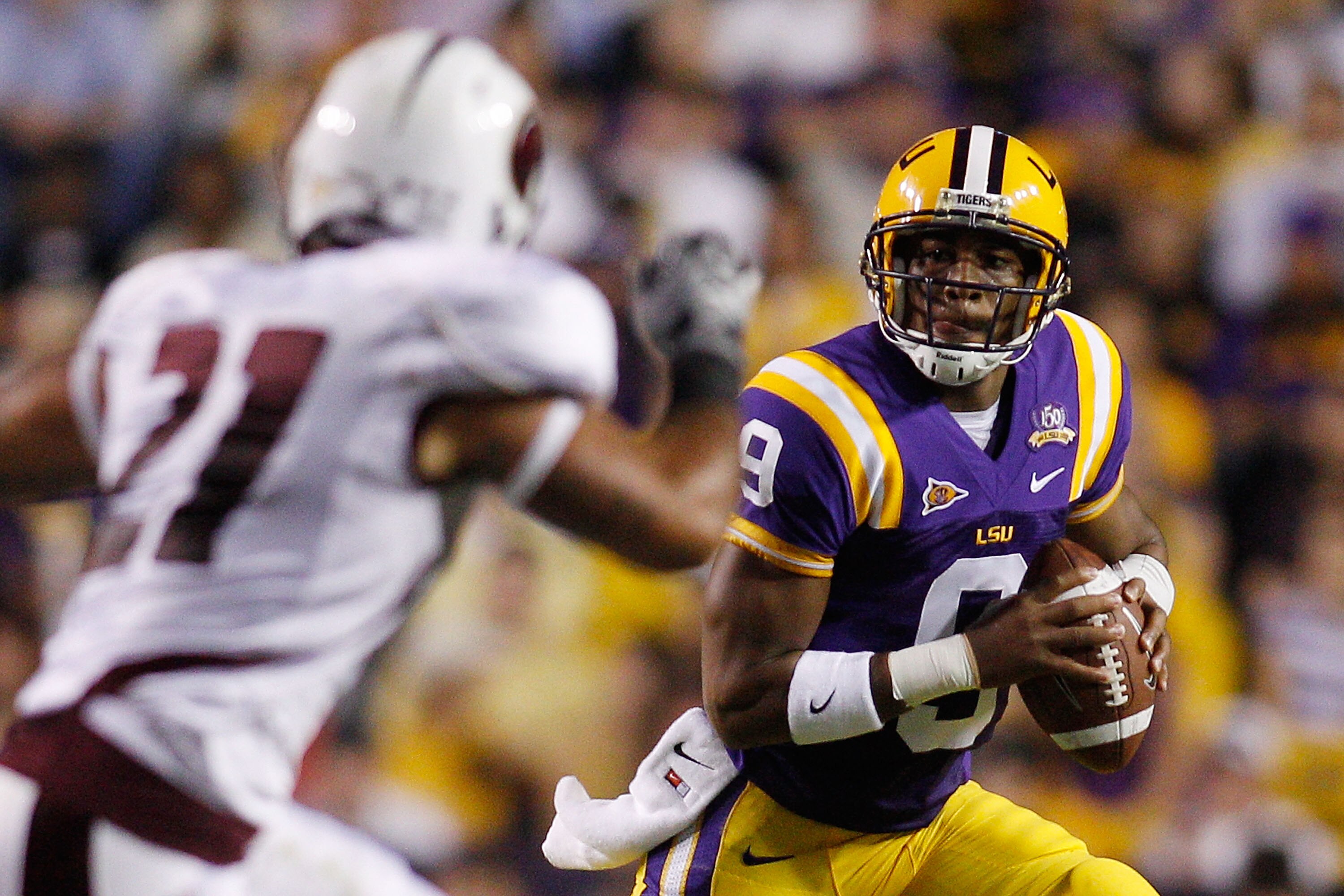 BATON ROUGE, LA - NOVEMBER 13:  Jordan Jefferson #9 of the Louisiana State University Tigers looks to throw a pass over Troy Giddens #21 of the University of Louisiana-Monroe Warhawks at Tiger Stadium on November 13, 2010 in Baton Rouge, Louisiana.   The