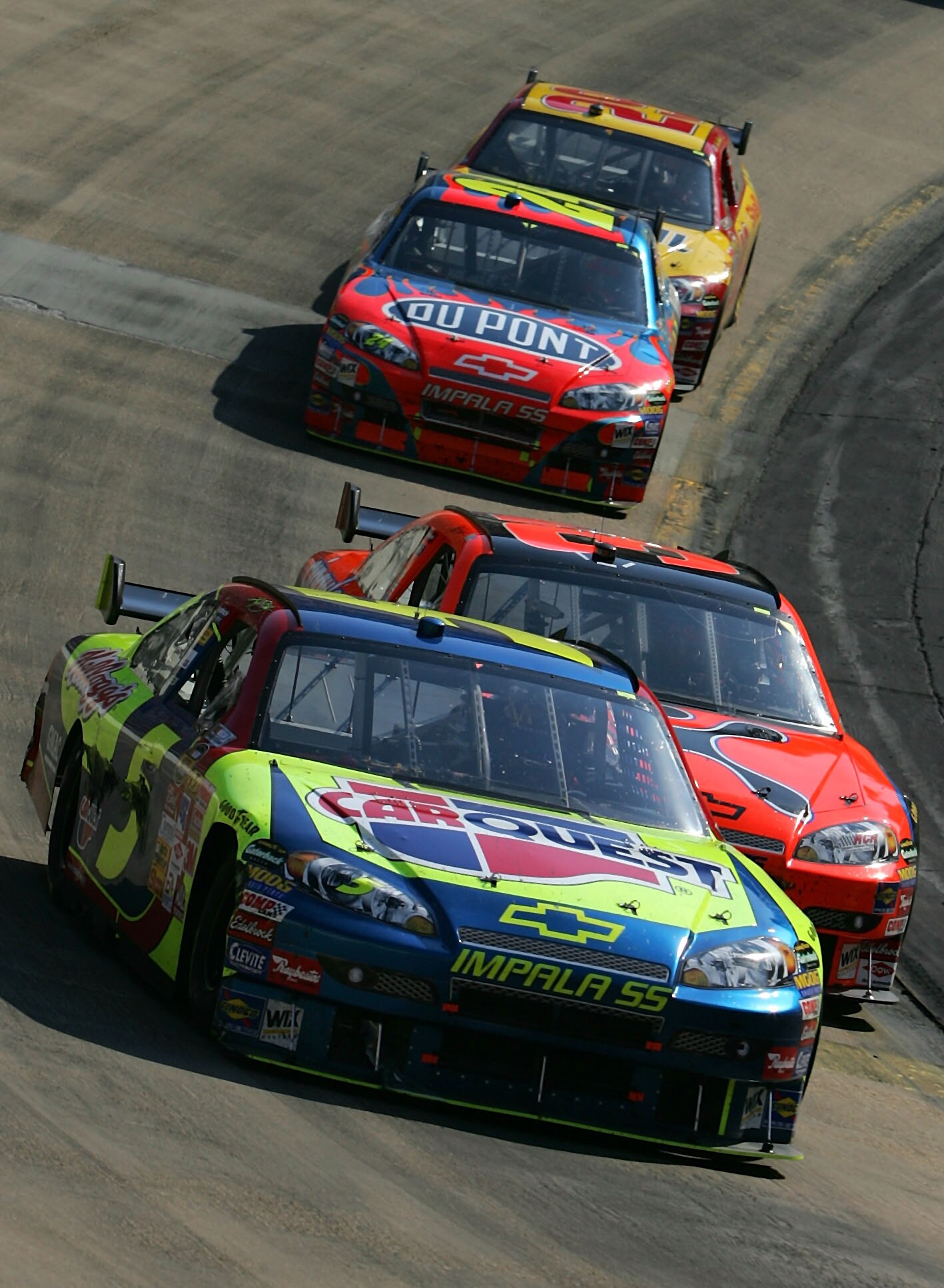 BRISTOL, TN - MARCH 25:  Kyle Busch, driver of the #5 Carquest/Kellogg's Chevrolet, leads Jeff Burton, driver of the #31 Cingular Wireless Chevrolet,  Jeff Gordon, driver of the #24 DuPont Chevrolet, and Kevin Harvick, driver of the #29 Shell/Pennzoil Che