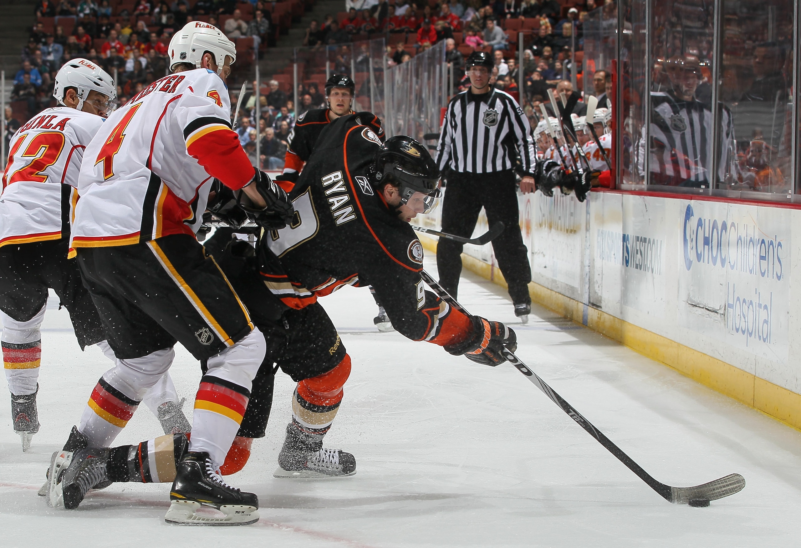 ANAHEIM, CA - DECEMBER 10:  Bobby Ryan #9 of the Anaheim Ducks is pursued by Jay Bouwmeester #4 of the Calgary Flames for the puck in the third period at the Honda Center on December 10, 2010 in Anaheim, California. The Ducks defeated the Flames 3-2 in a