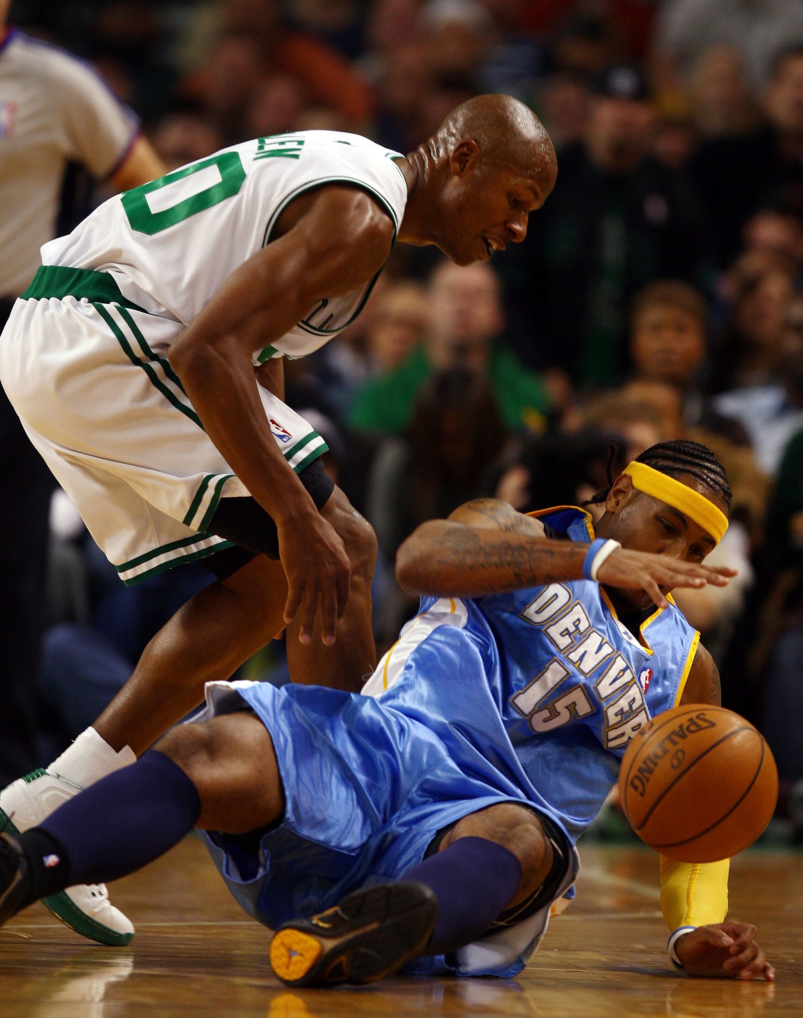 BOSTON - NOVEMBER 07:  Carmelo Anthony #15 of the Denver Nuggets tries to hang on to the ball as  Ray Allen #20 of the Boston Celtics looks for the steal on November 7, 2007 at the TD Banknorth Garden in Boston, Massachusetts.  NOTE TO USER: User expressl