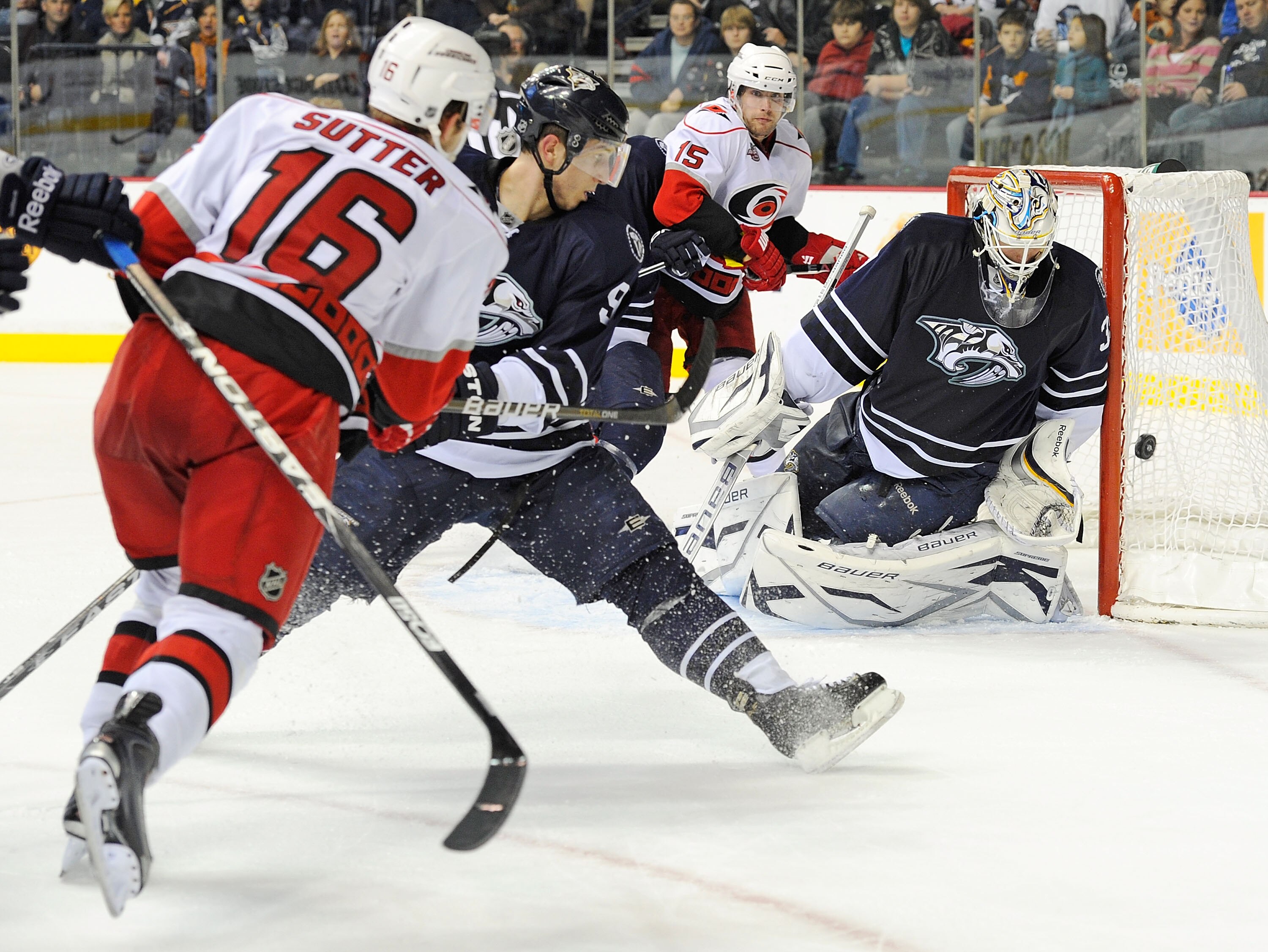 NASHVILLE, TN - DECEMBER 04:   Brandon Sutter #16 of the Carolina Hurricanes takes a shot wide of goalie Anders Lindback #39 of the Nashville Predators  on December 4, 2010 at the Bridgestone Arena in Nashville, Tennessee.  (Photo by Frederick Breedon/Get