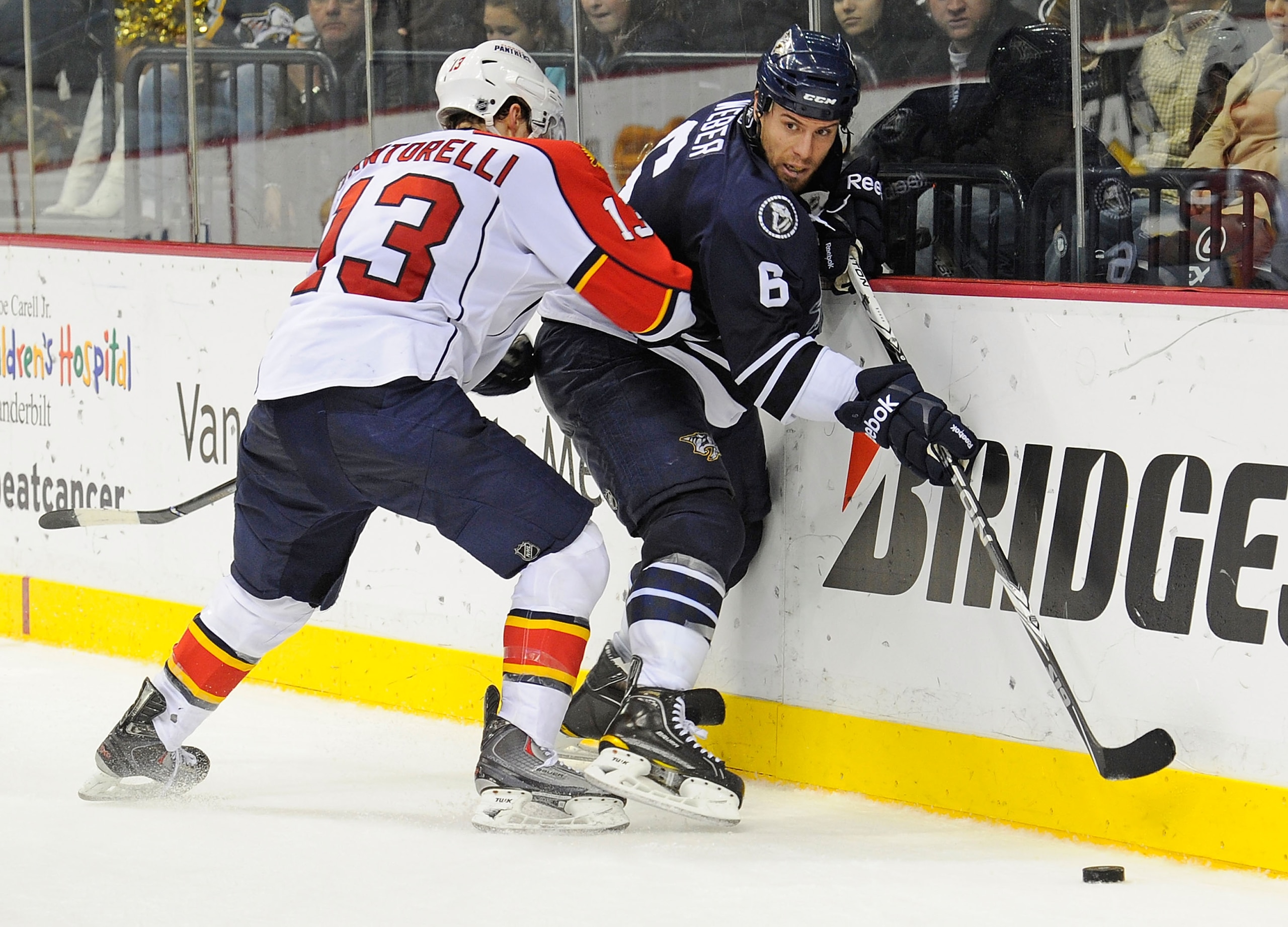 NASHVILLE, TN - DECEMBER 11:  Shea Weber #6 of the Nashville Predators figths through the check of Mike Santorelli #13 of the Florida Panthers on December 11, 2010 at the Bridgestone Arena in Nashville, Tennessee.  (Photo by Frederick Breedon/Getty Images