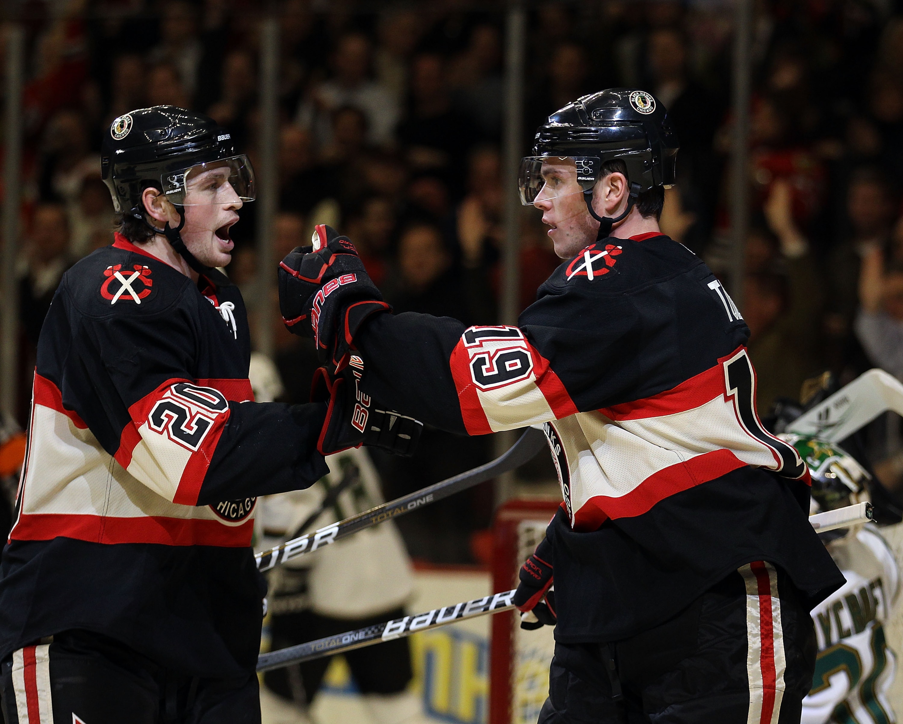 CHICAGO, IL - DECEMBER 08: Jonathan Toews #19 of the Chicago Blackhawks celebrates a first period goal with teammate Jack Skille #20 against the Dallas Stars at the United Center on December 8, 2010 in Chicago, Illinois. (Photo by Jonathan Daniel/Getty Im