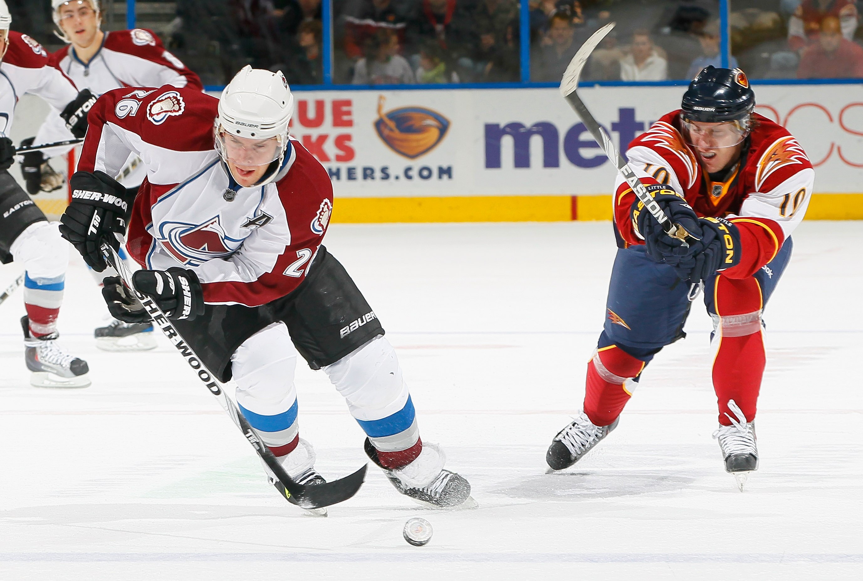 ATLANTA, GA - DECEMBER 10:  Paul Stastny #26 of the Colorado Avalanche controls the puck against Bryan Little #10 of the Atlanta Thrashers at Philips Arena on December 10, 2010 in Atlanta, Georgia.  (Photo by Kevin C. Cox/Getty Images)