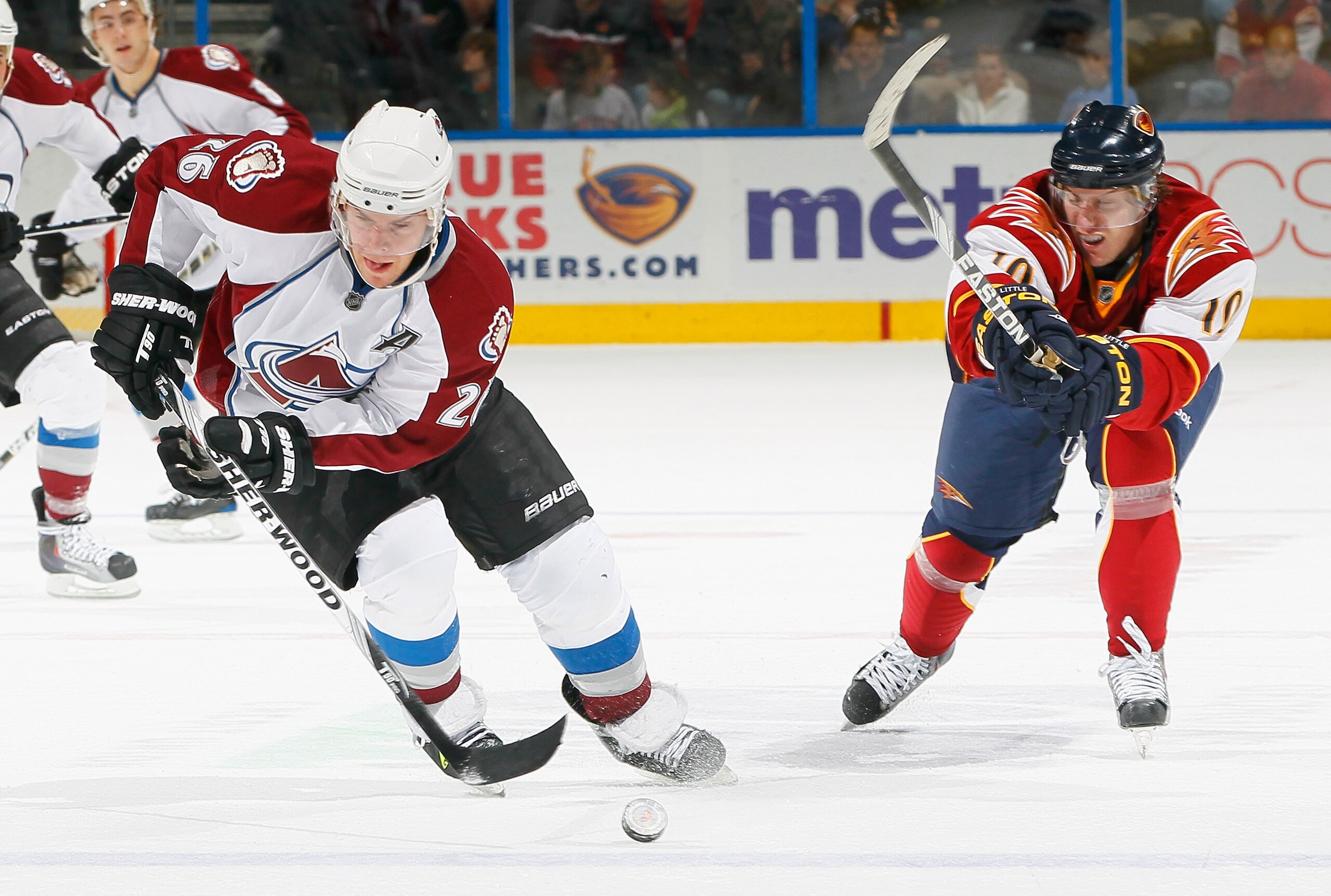 ATLANTA, GA - DECEMBER 10:  Paul Stastny #26 of the Colorado Avalanche controls the puck against Bryan Little #10 of the Atlanta Thrashers at Philips Arena on December 10, 2010 in Atlanta, Georgia.  (Photo by Kevin C. Cox/Getty Images)