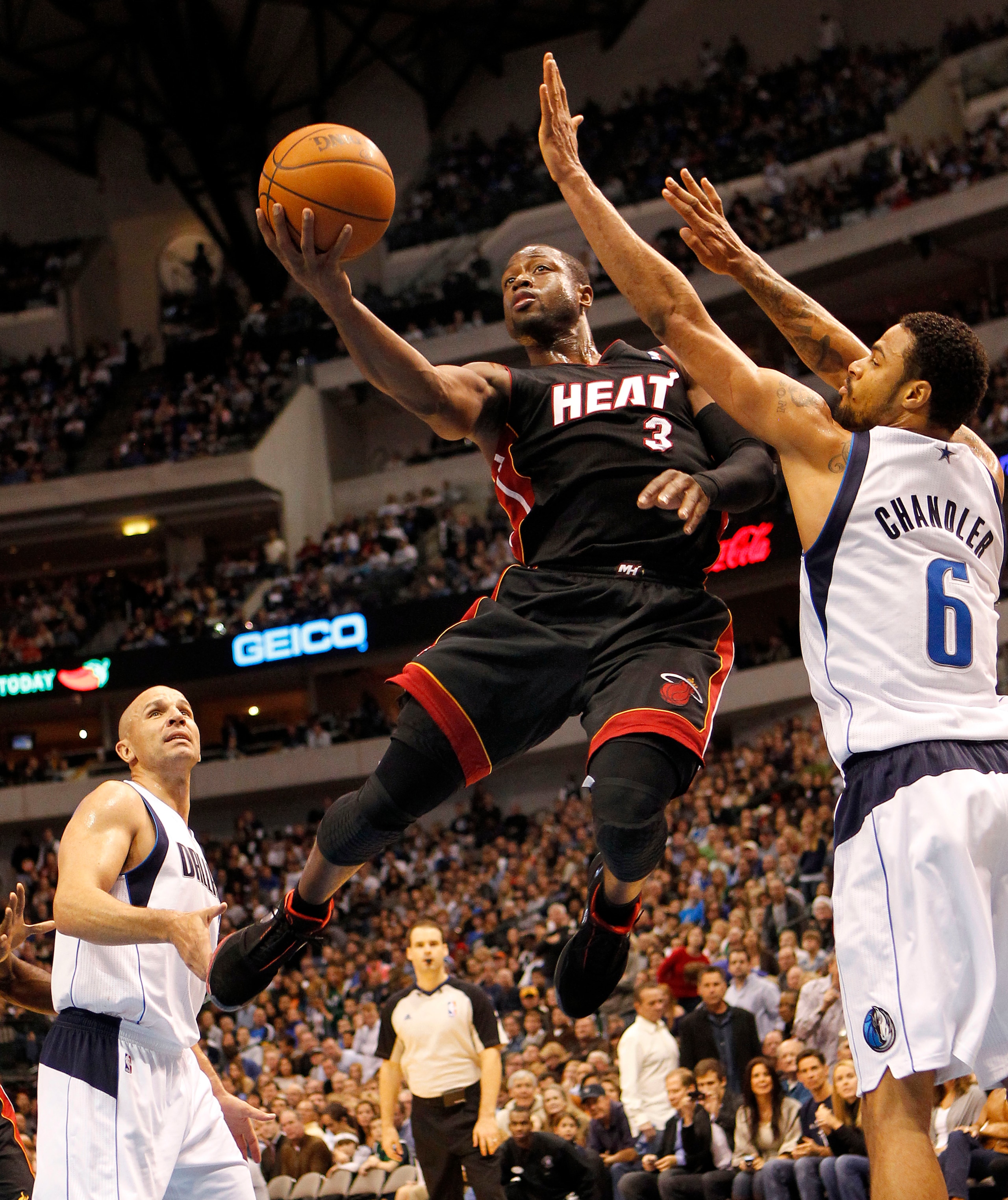 DALLAS - NOVEMBER 27: Dwyane Wade #3 of the Miami Heat shoots over Tyson Chandler #6 of the Dallas Mavericks on November 27, 2010 at the American Airlines Center in Dallas, Texas. NOTE TO USER: User expressly acknowledges and agrees that, by downloading a
