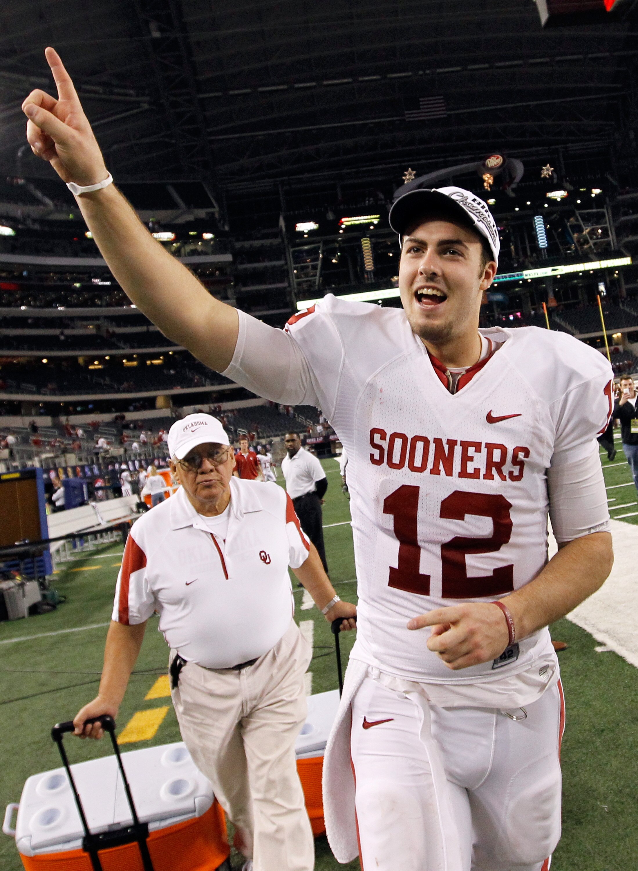 ARLINGTON, TX - DECEMBER 04:  Quarterback Landry Jones #12 of the Oklahoma Sooners celebrates after the Sooners beat the Nebraska Cornhuskers 23-20 at Cowboys Stadium on December 4, 2010 in Arlington, Texas.  (Photo by Tom Pennington/Getty Images)
