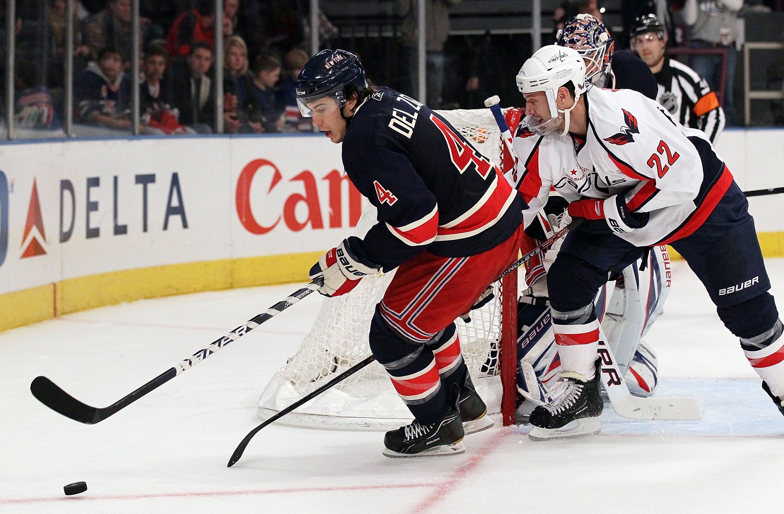 NEW YORK, NY - DECEMBER 12:  Michael Del Zotto #4 of the New York Rangers controls the puck against Mike Knuble #22 of the Washington Capitals on December 12, 2010 at Madison Square Garden in New York City. The Rangers defeated the Capitals 7-0.  (Photo b
