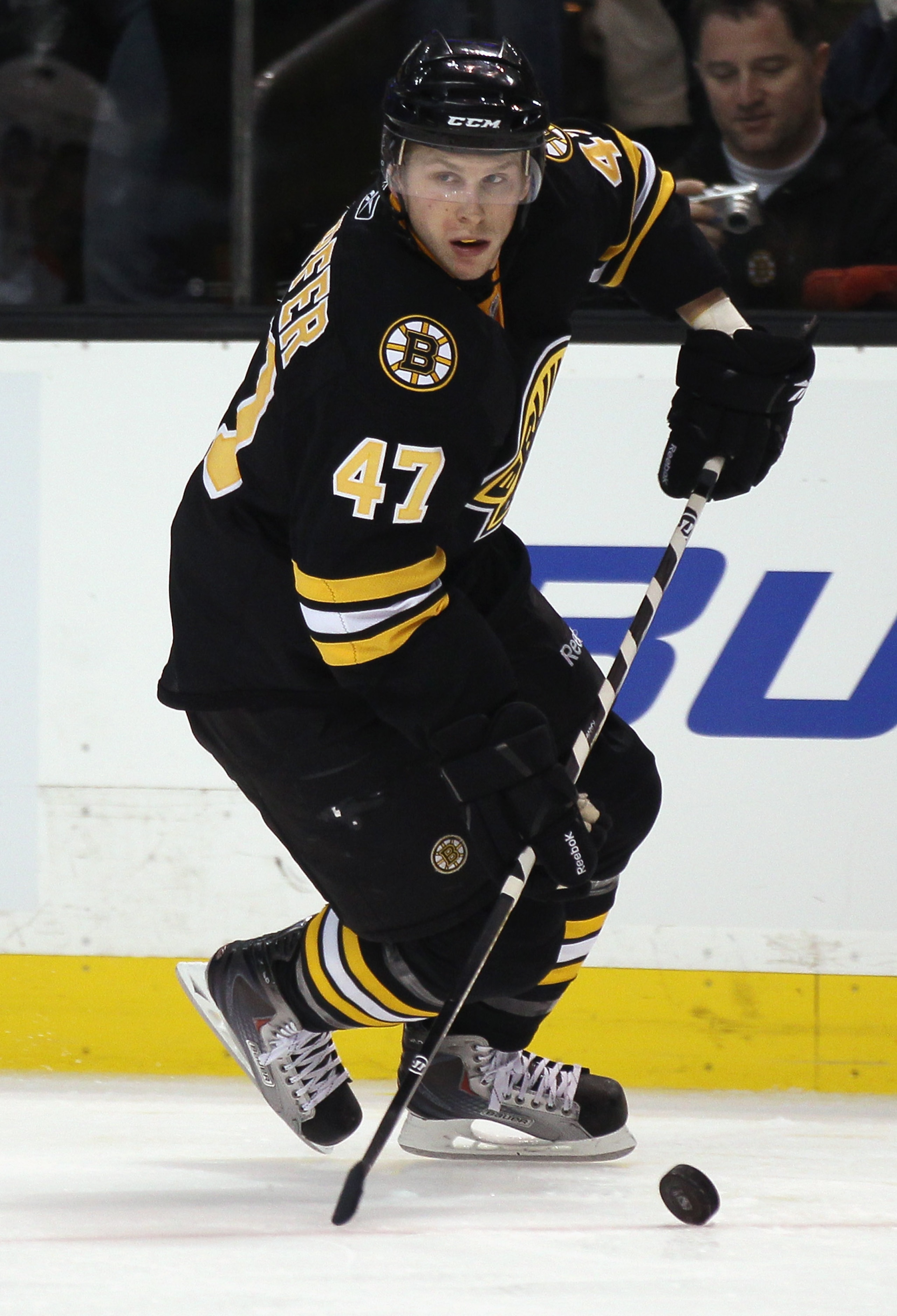 BOSTON, MA - DECEMBER 11:  Steven Kampfer #47 of the Boston Bruins takes the puck against the Philadelphia Flyers on December 11, 2010 at the TD Garden in Boston, Massachusetts.  (Photo by Elsa/Getty Images)