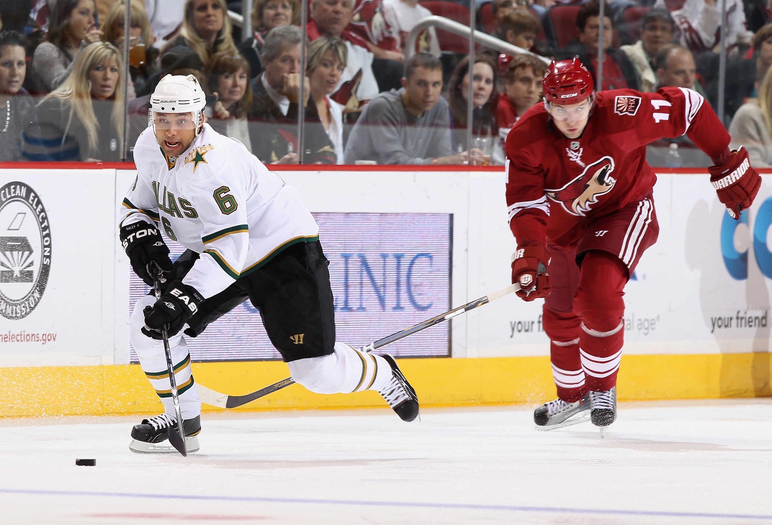 GLENDALE, AZ - DECEMBER 11:  Trevor Daley #6 of the Dallas Stars skates with the puck past Martin Hanzal #11 of the Phoenix Coyotes during the NHL game at Jobing.com Arena on December 11, 2010 in Glendale, Arizona. The Coyotes defeated the Stars 5-2. (Pho