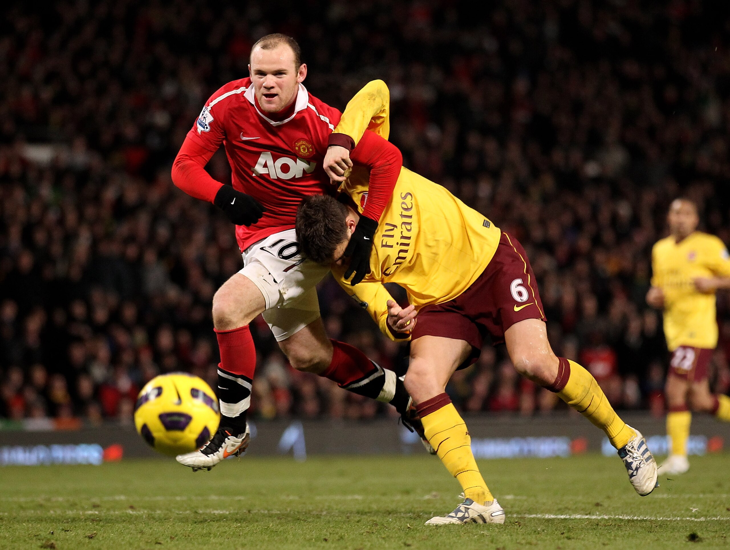 MANCHESTER, ENGLAND - DECEMBER 13: Wayne Rooney of Manchester United tangles with Laurent Koscielny of Arsenal during the Barclays Premier League match between Manchester United and Arsenal at Old Trafford on December 13, 2010 in Manchester, England. (P MANCHESTER, ENGLAND - DECEMBER 13: Wayne Rooney of Manchester United tangles with Laurent Koscielny of Arsenal during the Barclays Premier League match between Manchester United and Arsenal at Old Trafford on December 13, 2010 in Manchester, England. (P