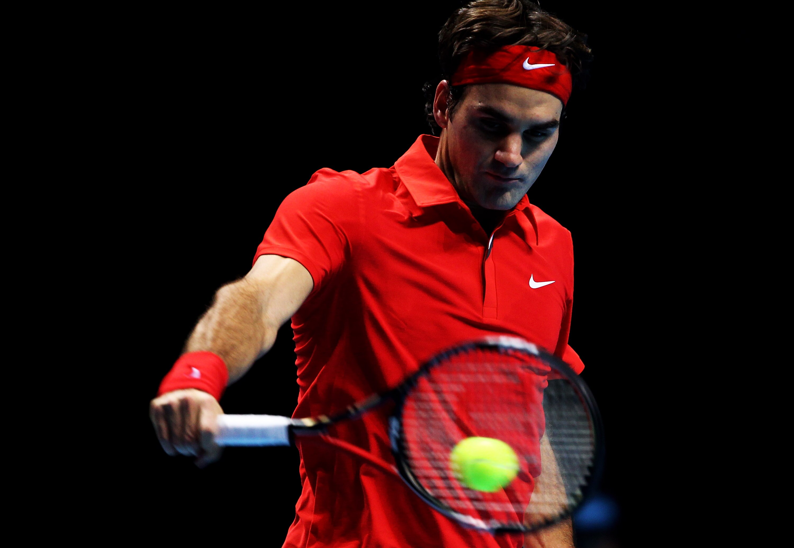 LONDON, ENGLAND - NOVEMBER 28:  Roger Federer of Switzerland plays a backhand during his men's final match against Rafael Nadal of Spain during the ATP World Tour Finals at O2 Arena on November 28, 2010 in London, England.  (Photo by Julian Finney/Getty I