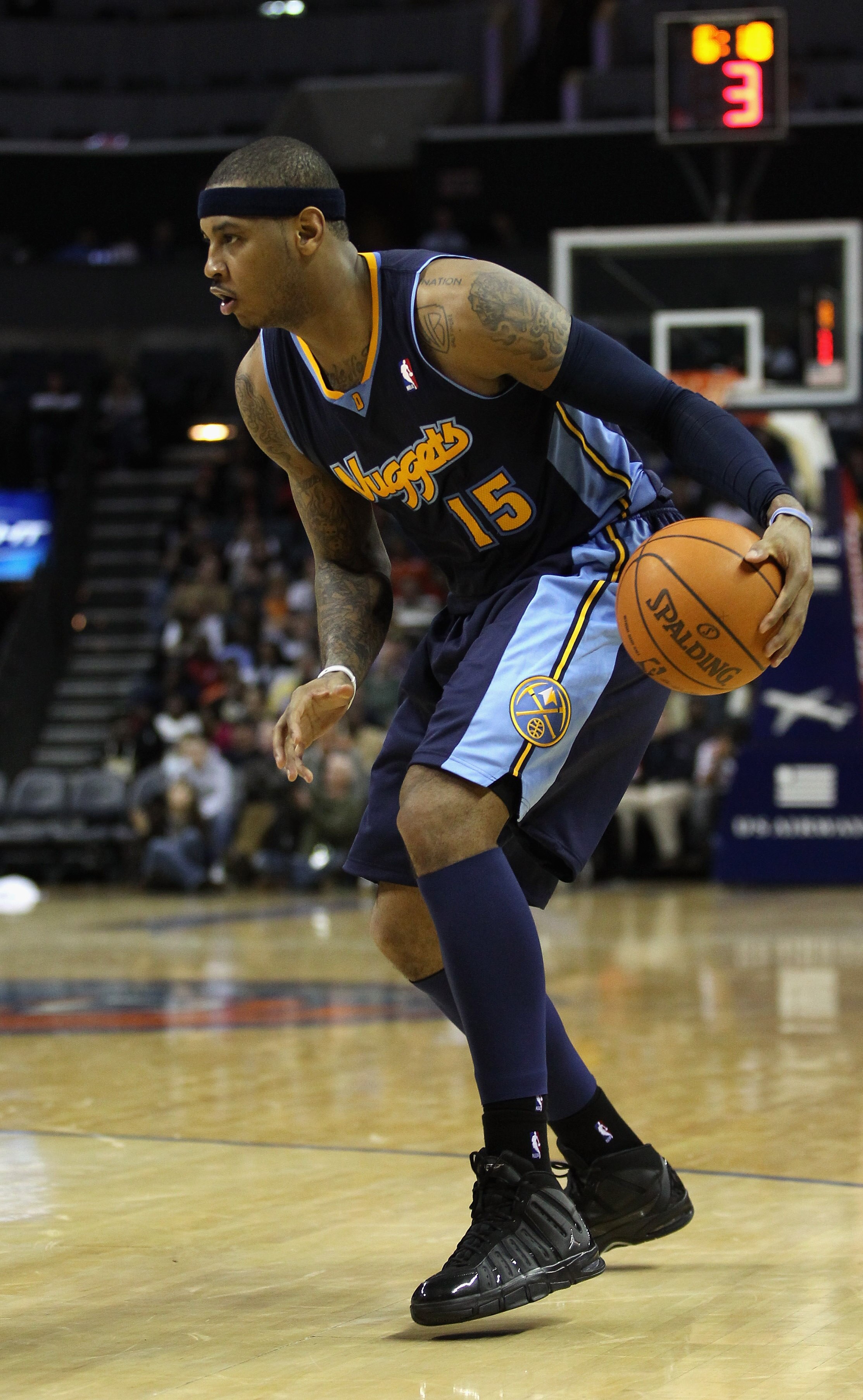CHARLOTTE, NC - DECEMBER 07:  Carmelo Anthony #15 of the Denver Nuggets watches on against the Charlotte Bobcats during their game at Time Warner Cable Arena on December 7, 2010 in Charlotte, North Carolina.  NOTE TO USER: User expressly acknowledges and
