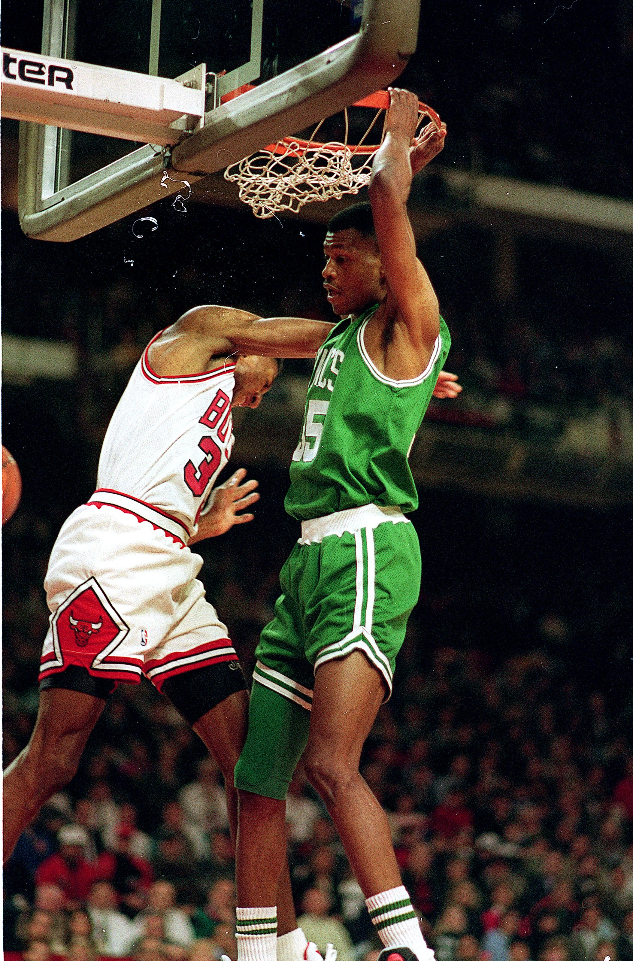 CHICAGO - DECEMBER 18:  Reggie Lewis of the Boston Celtics makes a slam dunk during the NBA game against the Chicago Bulls in the United Center on December 18, 1993 in Chicago, Illinois. NOTE TO USER: User expressly acknowledges and agrees that, by downlo