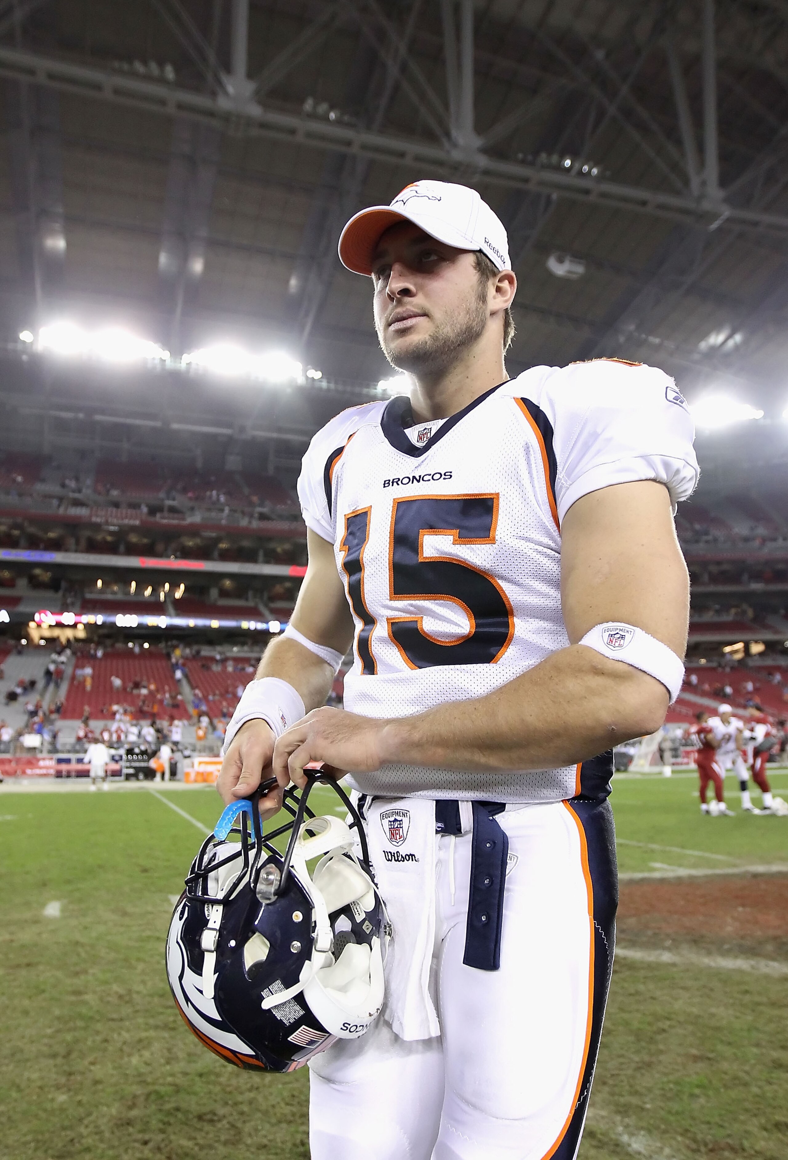 GLENDALE, AZ - DECEMBER 12:  Quarterback Tim Tebow #15 of the Denver Broncos walks off the field following the NFL game against the Arizona Cardinals at the University of Phoenix Stadium on December 12, 2010 in Glendale, Arizona.  The Cardinals defeated t