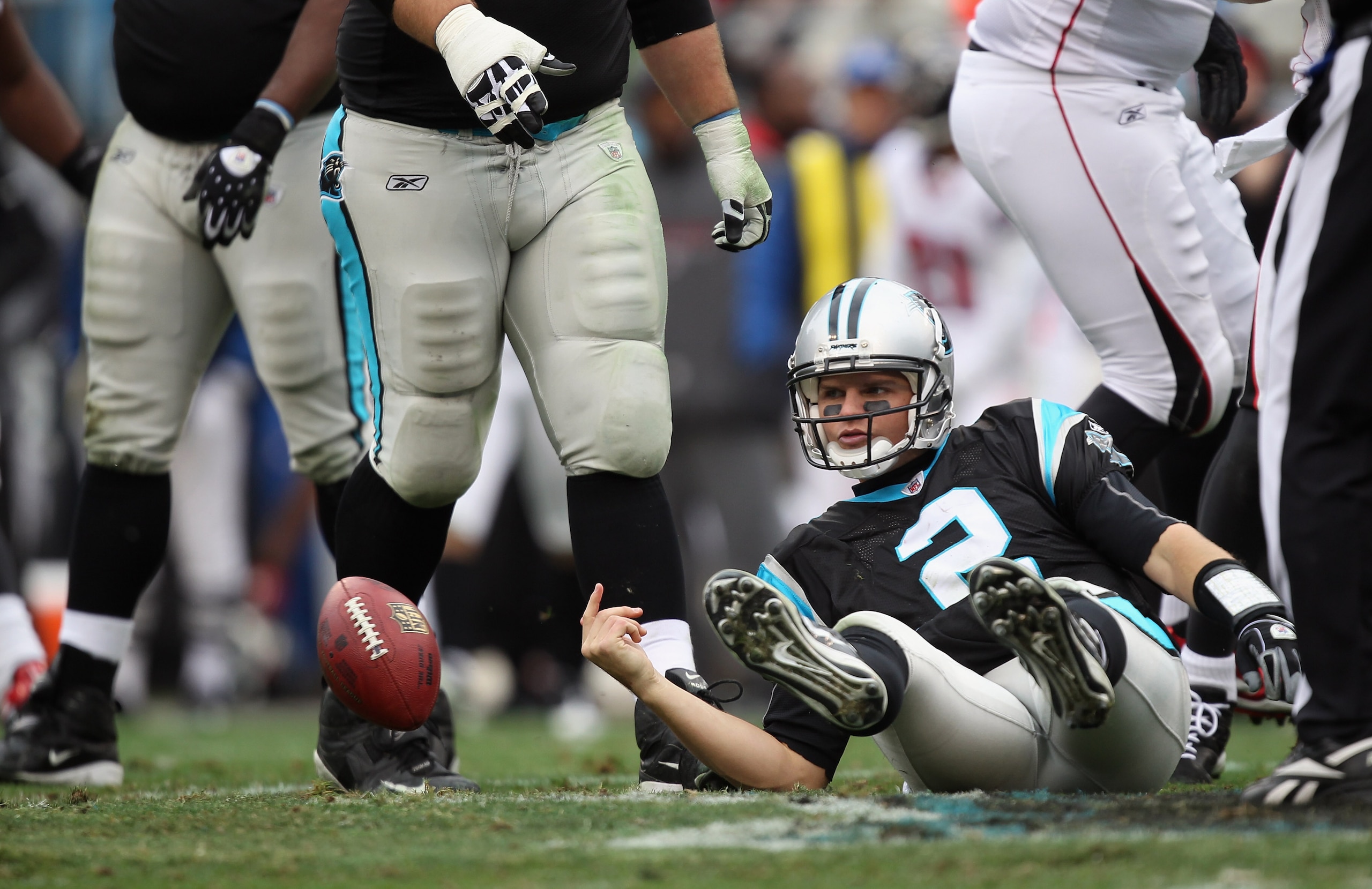 CHARLOTTE, NC - DECEMBER 12:  Casey Clausen #2 of the Carolina Panthers reacts as he is knocked to the ground against the Atlanta Falcons during their game at Bank of America Stadium on December 12, 2010 in Charlotte, North Carolina.  (Photo by Streeter L