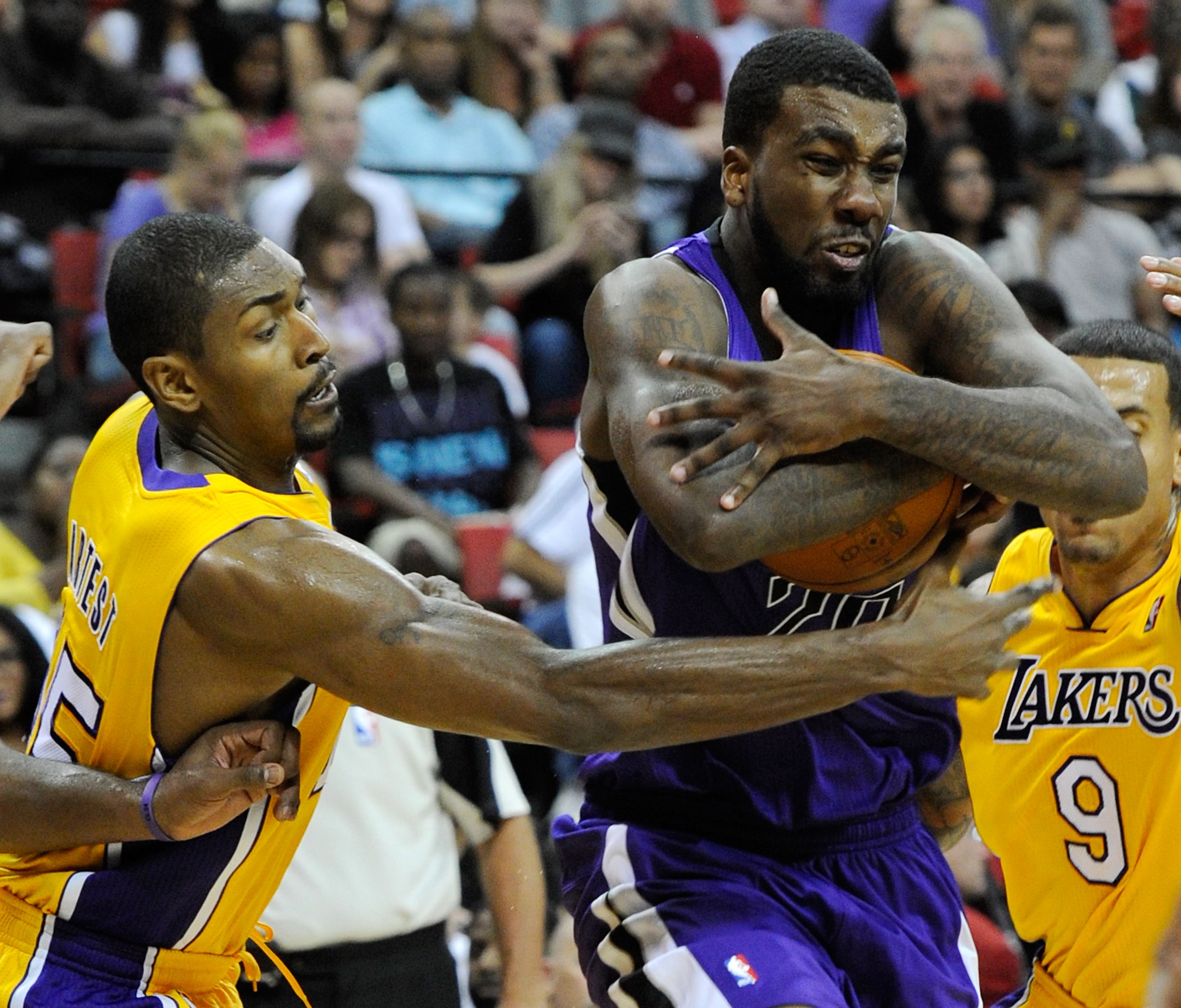 LAS VEGAS - OCTOBER 13: Ron Artest #15 of the Los Angeles Lakers tries to steal the ball from Donte Greene #20 of the Sacramento Kings during their preseason game at the Thomas & Mack Center October 13, 2010 in Las Vegas, Nevada. The Lakers won 98-95. NO LAS VEGAS - OCTOBER 13: Ron Artest #15 of the Los Angeles Lakers tries to steal the ball from Donte Greene #20 of the Sacramento Kings during their preseason game at the Thomas & Mack Center October 13, 2010 in Las Vegas, Nevada. The Lakers won 98-95. NO