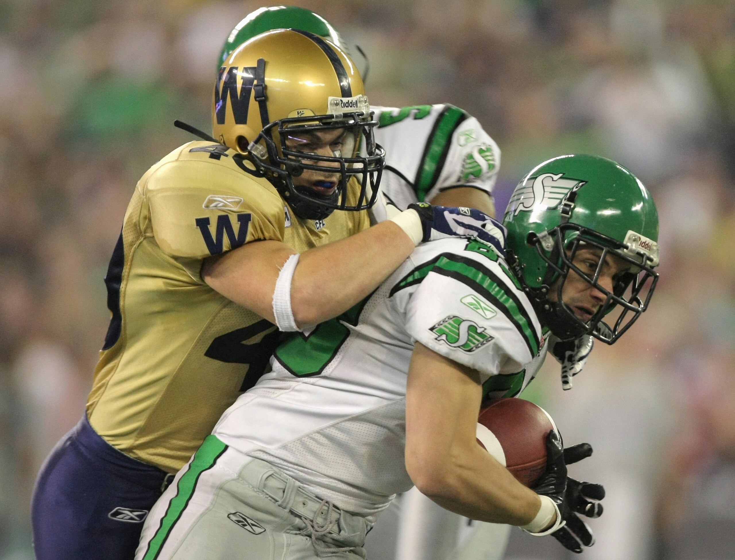 TORONTO - NOVEMBER 25:  Andy Fantuz #83 of the Saskatchewan Rough Riders tries to break free from Cam Hall #40 of the Winnipeg Blue Bombers during the third quarter in the 95th Grey Cup on November 25, 2007 at the Rogers Centre in Toronto, Ontario, Canada