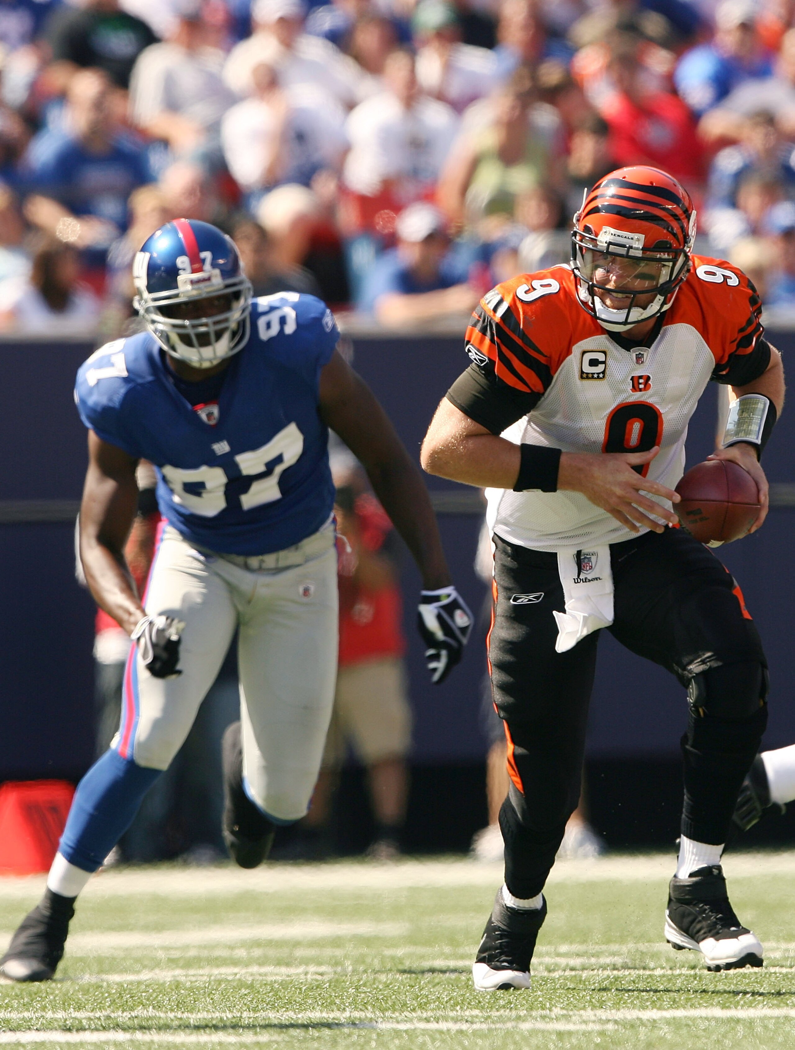 EAST RUTHERFORD, NJ - SEPTEMBER 21: Carson Palmer #9 of the Cincinnati Bengals scrambles as Mathias Kiwanuka #97 of the New York Giants defends on September 21, 2008 at Giants Stadium in East Rutherford, New Jersey  (Photo by Elsa/Getty Images)