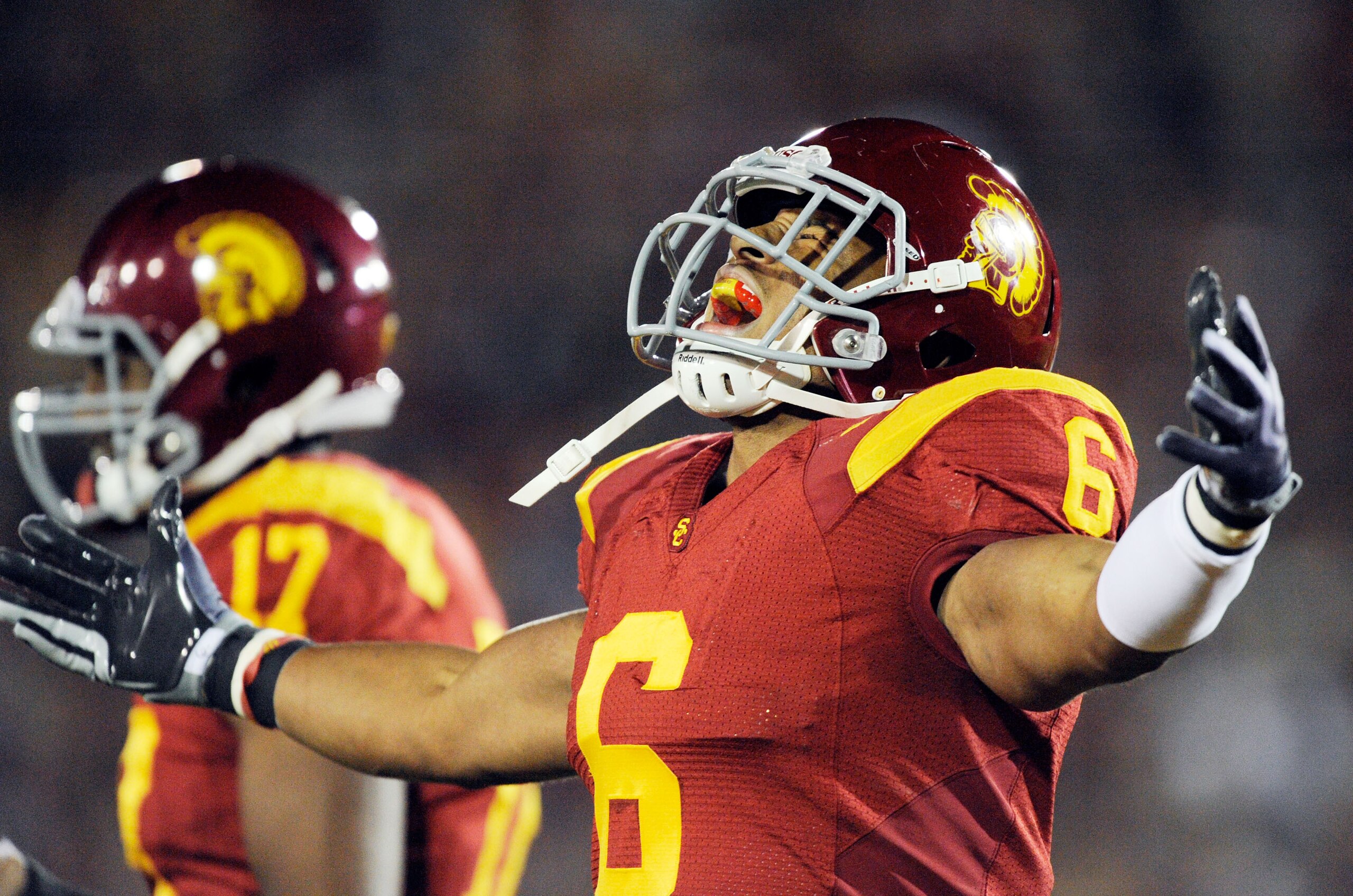 LOS ANGELES, CA - NOVEMBER 28:  Linebacker Malcolm Smith #6 of the USC Trojans celebrates after scoring a touchdown after intercepting a pass by quarterback Kevin Prince #14 of the UCLA Bruins and running it back for 62-yards during the first quarter of t