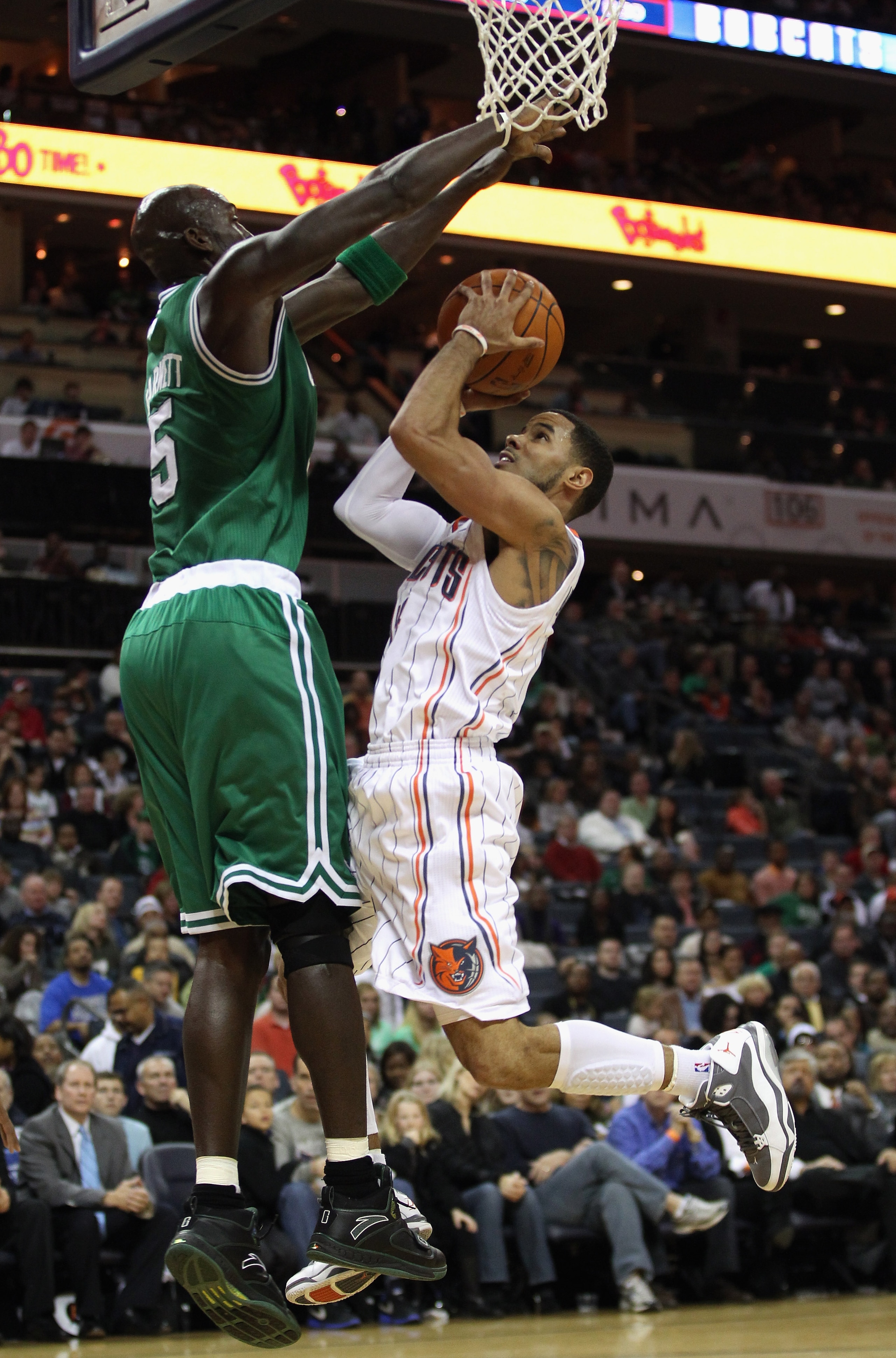 CHARLOTTE, NC - DECEMBER 11: Kevin Garnett #5 of the Boston Celtics tries to stop D.J. Augustin #14 of the Charlotte Bobcats during their game at Time Warner Cable Arena on December 11, 2010 in Charlotte, North Carolina. NOTE TO USER: User expressly ackn CHARLOTTE, NC - DECEMBER 11: Kevin Garnett #5 of the Boston Celtics tries to stop D.J. Augustin #14 of the Charlotte Bobcats during their game at Time Warner Cable Arena on December 11, 2010 in Charlotte, North Carolina. NOTE TO USER: User expressly ackn