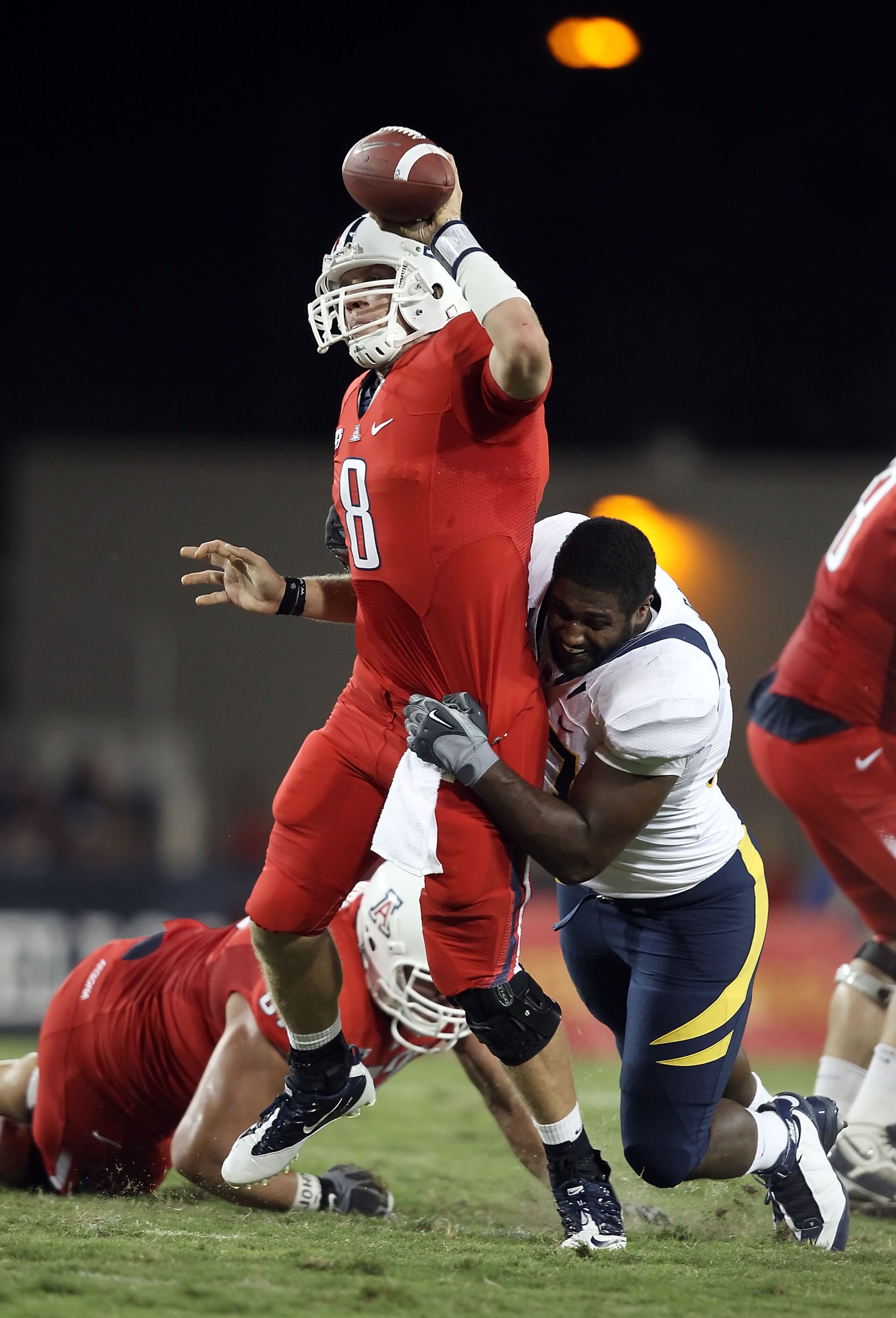 TUCSON, AZ - SEPTEMBER 25: Quarterback Nick Foles #8 of the Arizona Wildcats is pressured into throwing an incomplete pass by Cameron Jordan #97 of the California Bears during the first quarter of the college football game at Arizona Stadium on September TUCSON, AZ - SEPTEMBER 25: Quarterback Nick Foles #8 of the Arizona Wildcats is pressured into throwing an incomplete pass by Cameron Jordan #97 of the California Bears during the first quarter of the college football game at Arizona Stadium on September