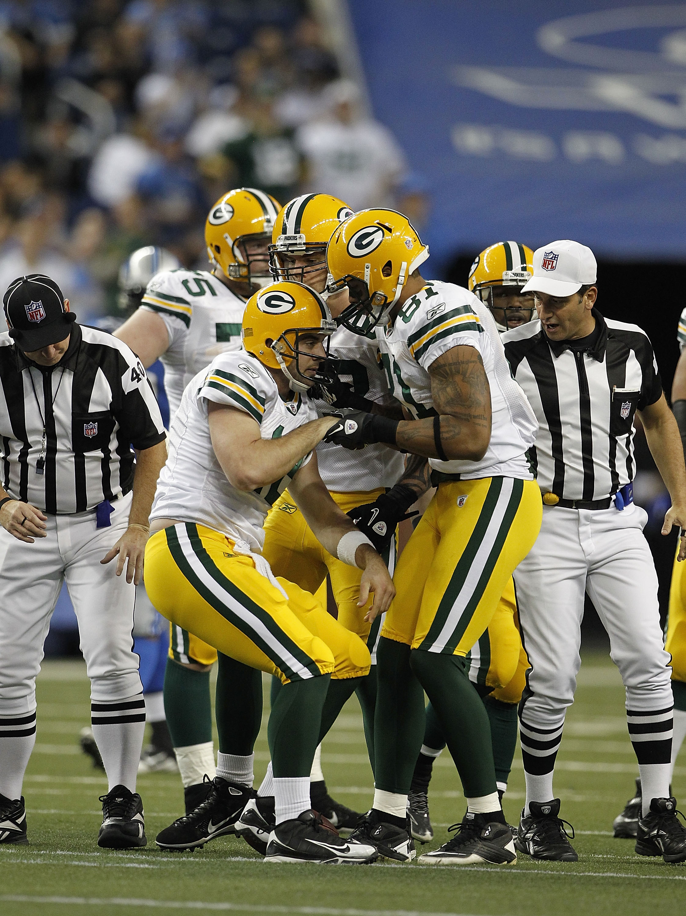 DETROIT - DECEMBER 12: Andrew Quarless #81 of the Green Bay Packers helps Aaron Rogers #12 of the Green Bay Packers up during the second quarter of the game against the Detroit Lions at Ford Field on December 12, 2010 in Detroit, Michigan.  (Photo by Leon