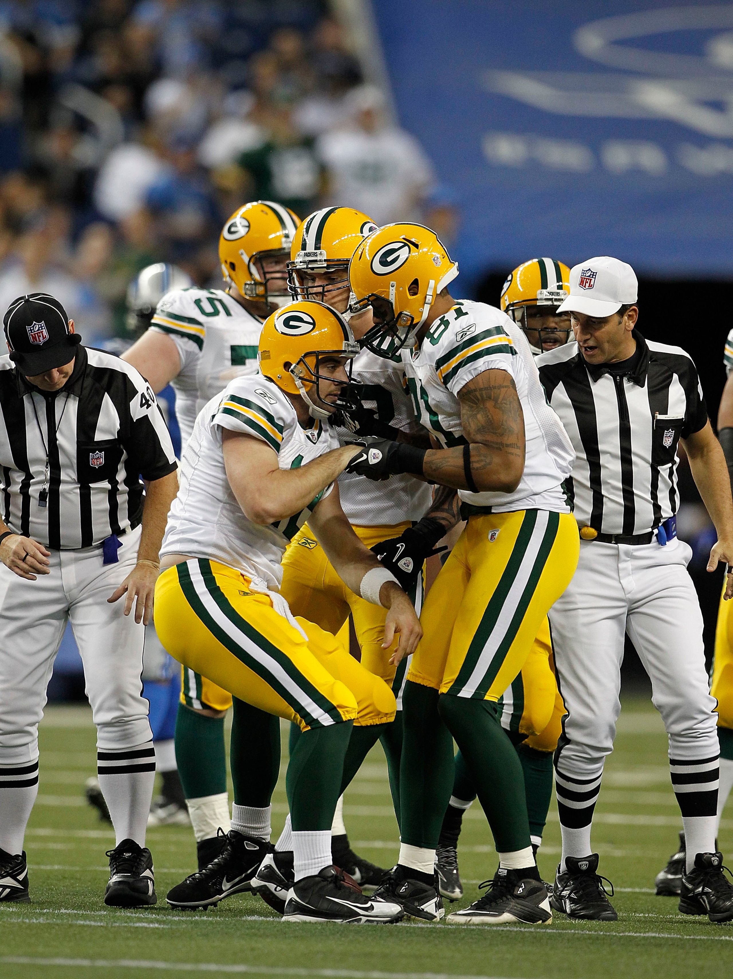 DETROIT - DECEMBER 12: Andrew Quarless #81 of the Green Bay Packers helps Aaron Rogers #12 of the Green Bay Packers up during the second quarter of the game against the Detroit Lions at Ford Field on December 12, 2010 in Detroit, Michigan.  (Photo by Leon