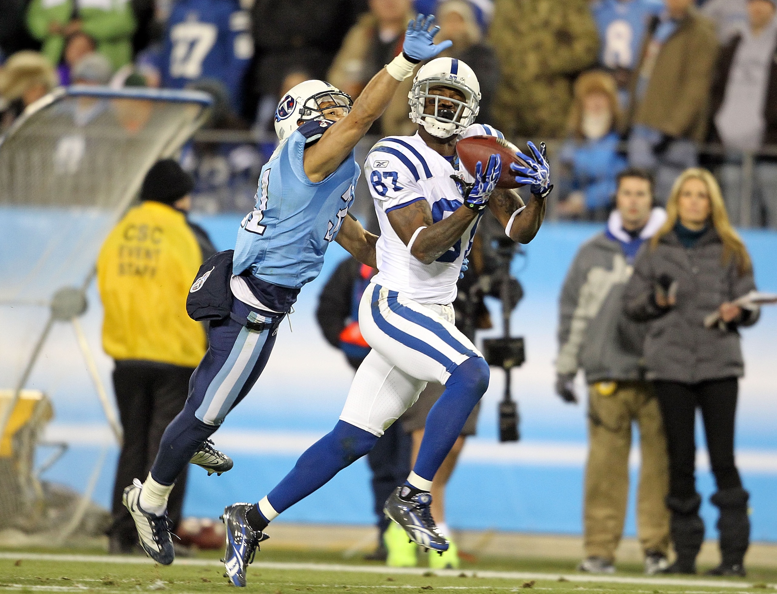 NASHVILLE, TN - DECEMBER 09:  Reggie Wayne #87 of the Indianapolis Colts catches a pass while defended by Cortland Finnegan #31  of the Tennessee Titans during the NFL game at LP Field on December 9, 2010 in Nashville, Tennessee.  (Photo by Andy Lyons/Get