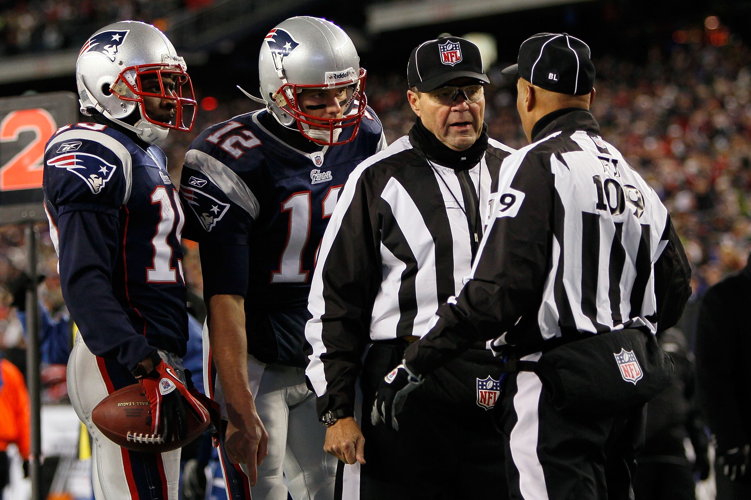 FOXBORO, MA - DECEMBER 06:  Brandon Tate #19 (L) and Tom Brady #12 of the New England Patriots listen in on the referees as they rule the Tate successfully scored a 4-yard touchdown reception in the second quarter against the New York Jets at Gillette Sta