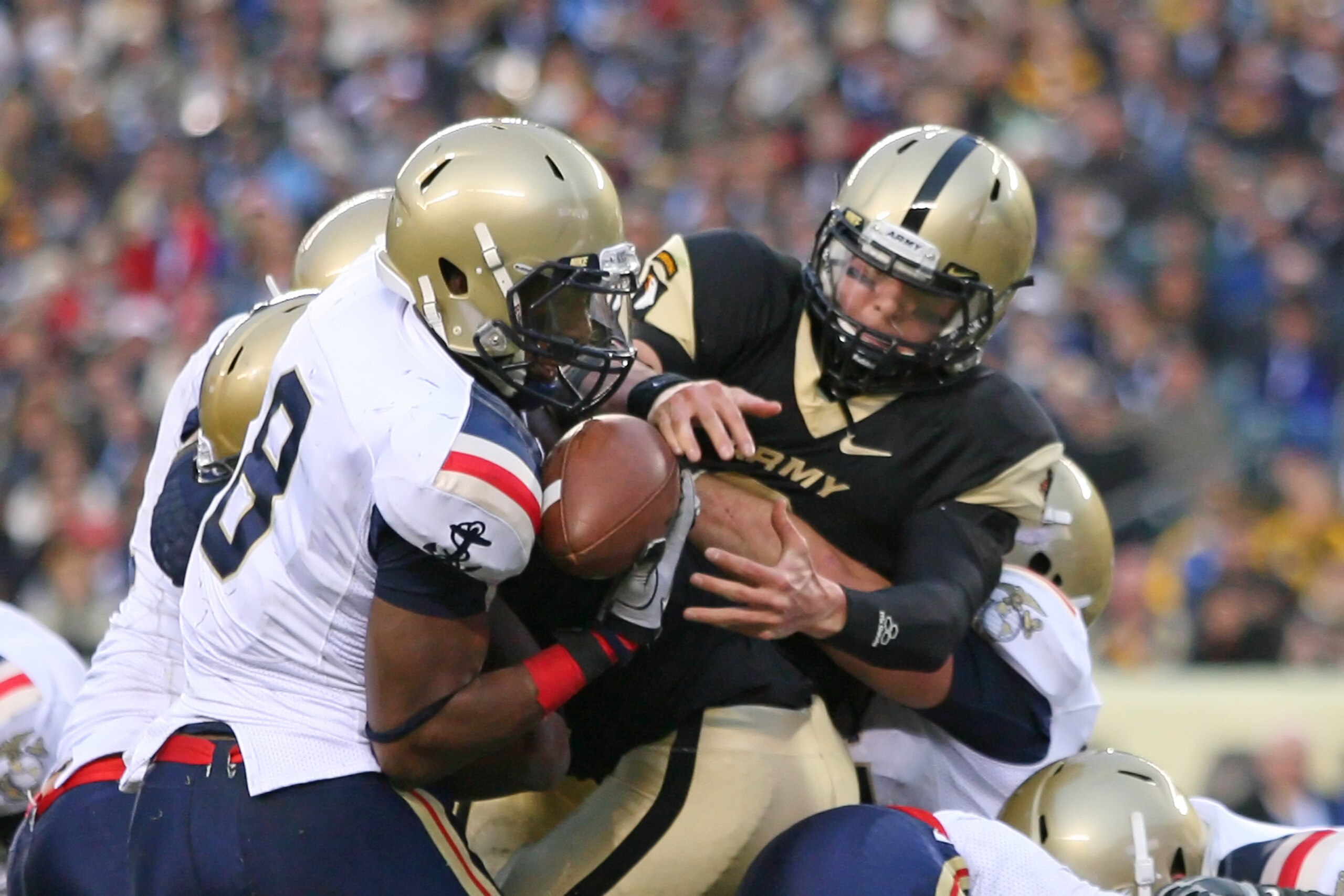 PHILADELPHIA - DECEMBER 11: Quarterback Trent Steelman #8 of the Army Black Knights is stripped of the ball by safety Wyatt Middleton #8 of the Navy Midshipmen during the game on December 11, 2010 at Lincoln Financial Field in Philadelphia, Pennsylvania. PHILADELPHIA - DECEMBER 11: Quarterback Trent Steelman #8 of the Army Black Knights is stripped of the ball by safety Wyatt Middleton #8 of the Navy Midshipmen during the game on December 11, 2010 at Lincoln Financial Field in Philadelphia, Pennsylvania.