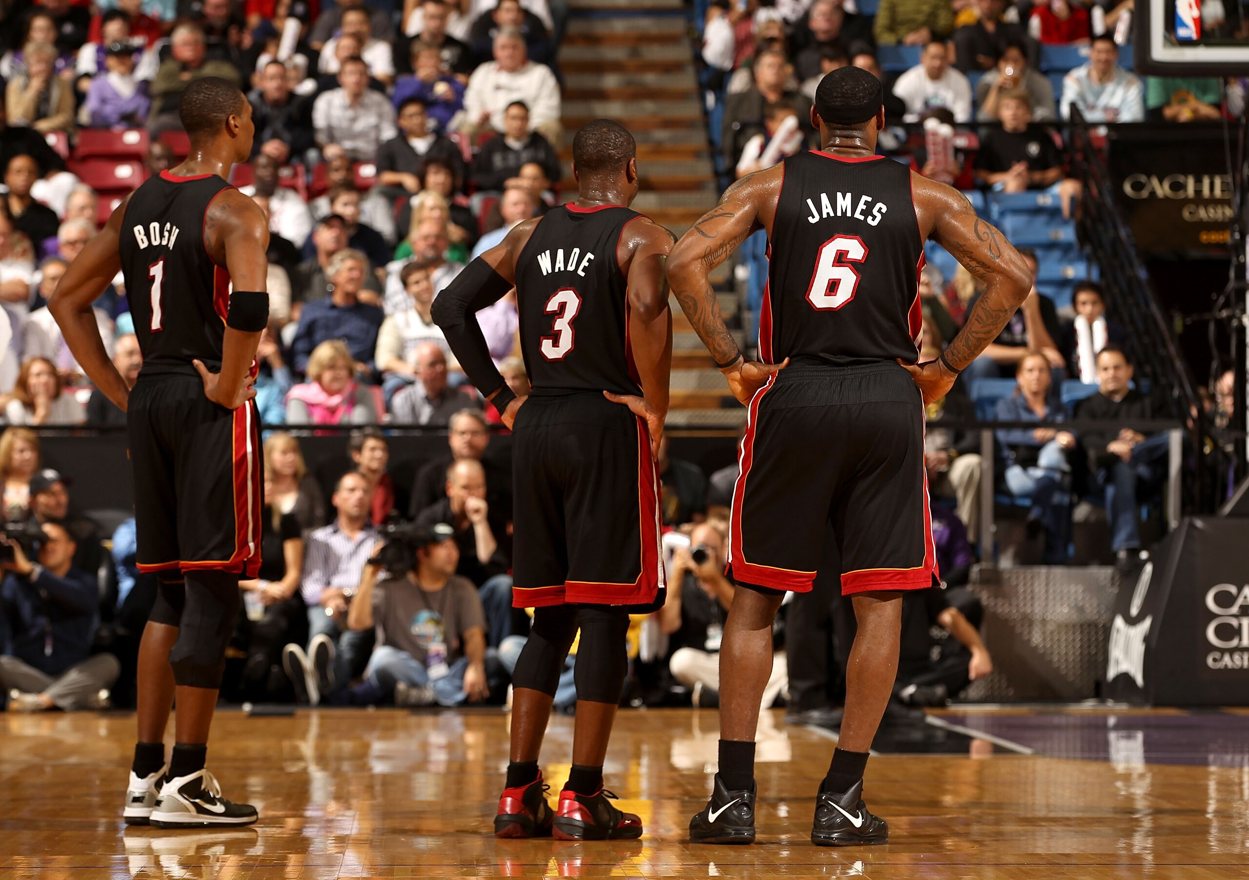 SACRAMENTO, CA - DECEMBER 11:  Chris Bosh #1, Dwayne Wade #3 and Lebron James #6 of the Miami Heat stand on to the court during the shooting of a technical foul during their game against the Sacramento Kings at ARCO Arena on December 11, 2010 in Sacrament