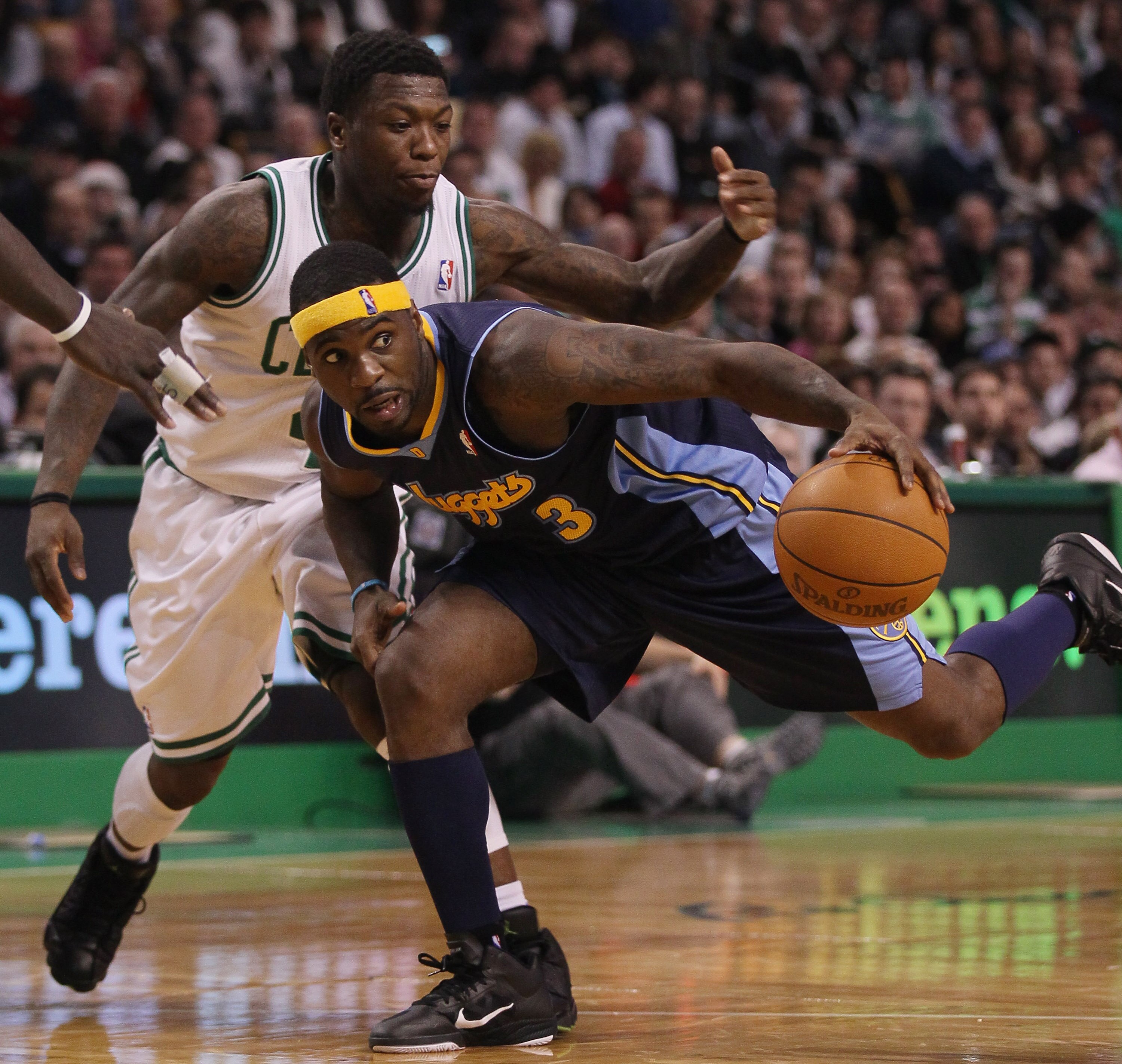 BOSTON, MA - DECEMBER 08:  Ty Lawson #3 of the Denver Nuggets tries to get around Nate Robinson #4 of the Boston Celtics on December 8, 2010 at the TD Garden in Boston, Massachusetts. The Celtics defeated the Nuggets 105-89. NOTE TO USER: User expressly a