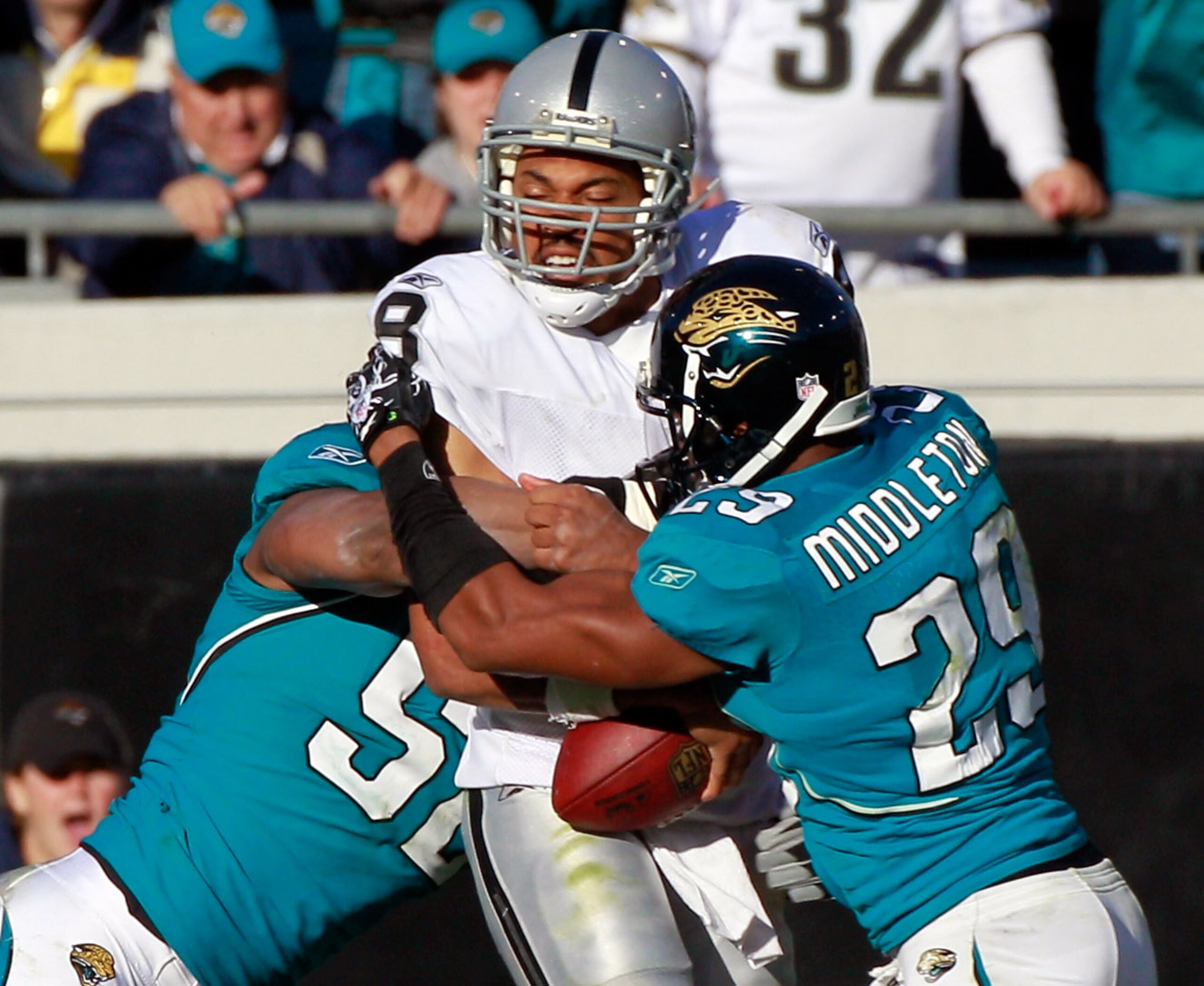 JACKSONVILLE, FL - DECEMBER 12:  Jason Cambell #8 of the Oakland Raiders is sacked by  William Middleton #29 and Daryl Smith #52 of the Jacksonville Jaguars during the game at EverBank Field on December 12, 2010 in Jacksonville, Florida.  (Photo by Sam Gr