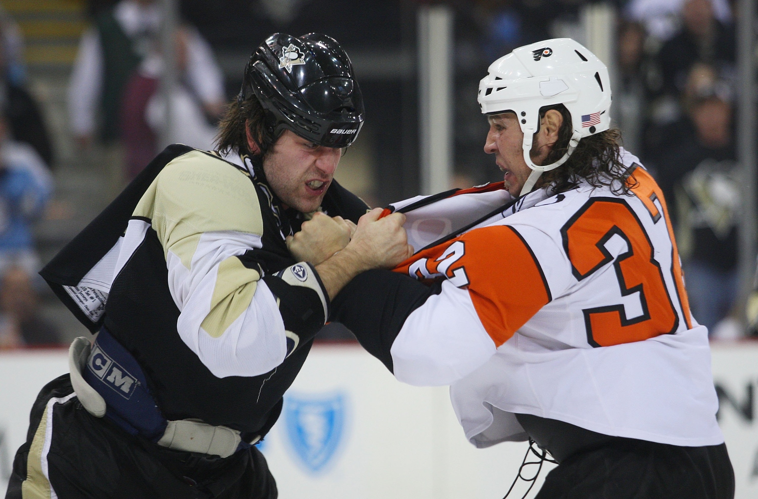 PITTSBURGH - DECEMBER 15:  Riley Cote #32 of the Philadelphia Flyers and Eric Godard #28 of the Pittsburgh Penguins fight during the first period at the Mellon Arena on December 15, 2009 in Pittsburgh, Pennsylvania. The Penguins defeated the Flyers 6-1.