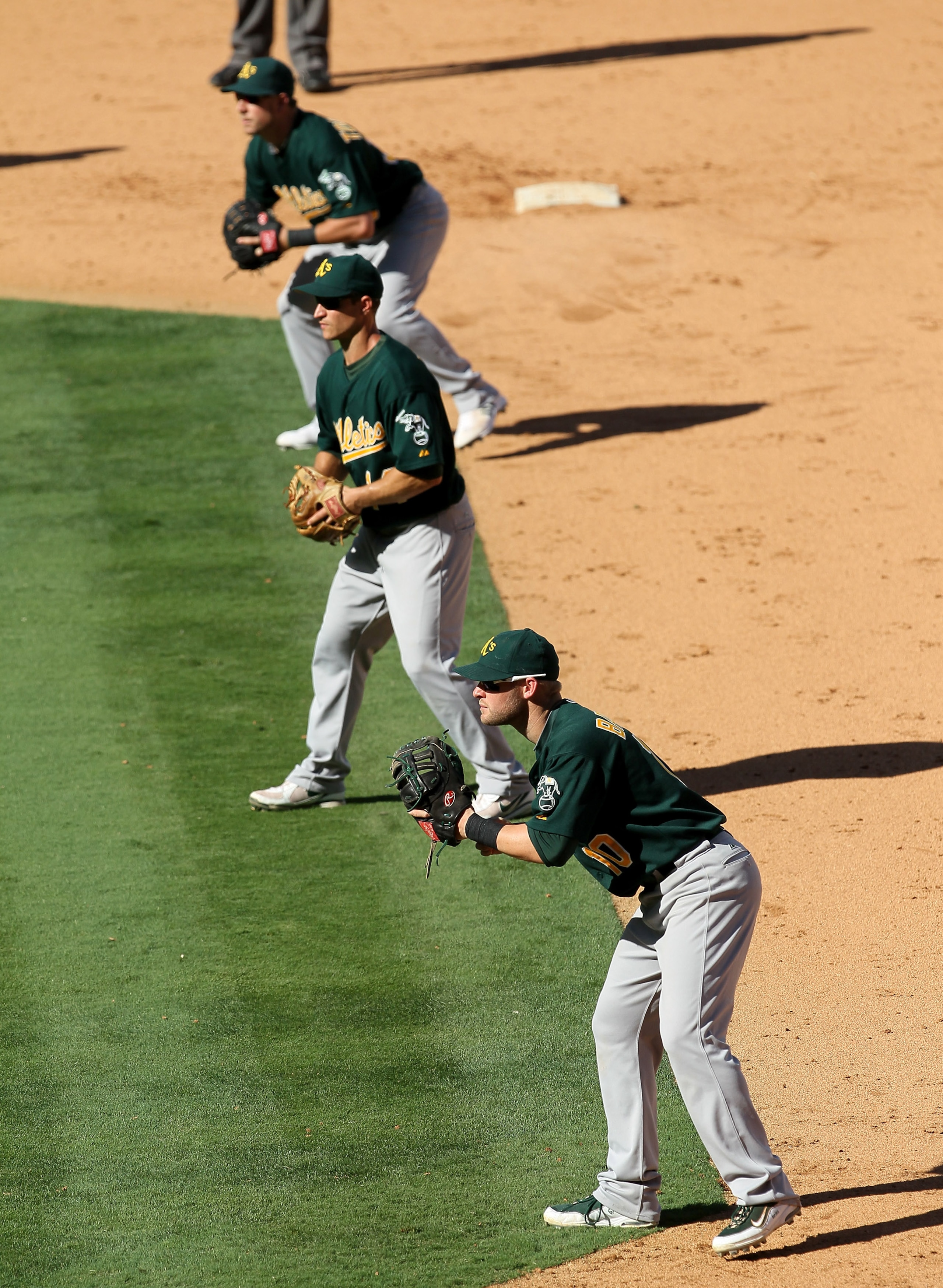ANAHEIM, CA - SEPTEMBER 29:  First baseman Daric Barton #14, second baseman Mark Ellis #14, and extra infielder Steven Tolleson #30 of the Oakland Athletics fill the right side of the infield as the Los Angeles Angels of Anaheim bat with the bases loaded,