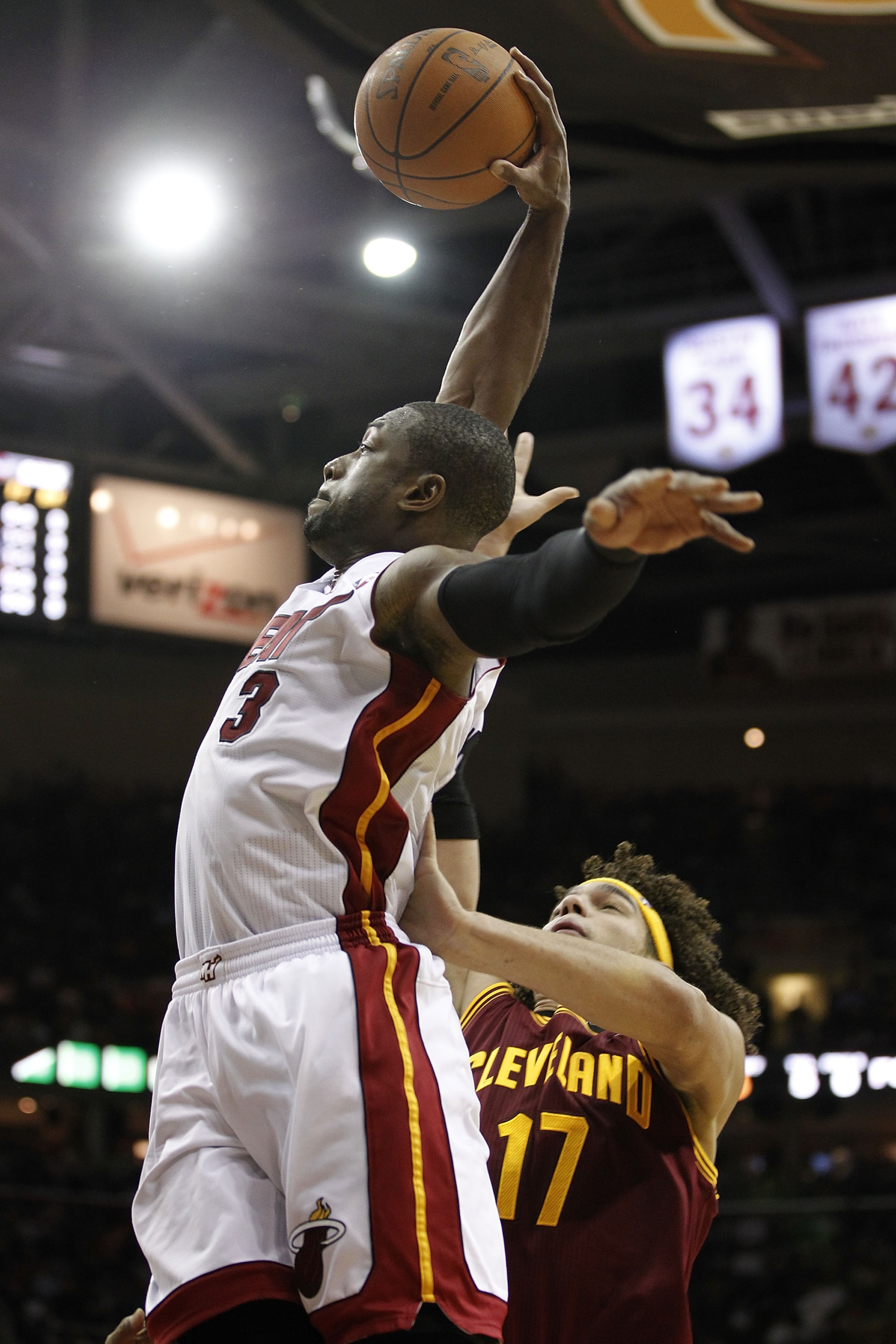 CLEVELAND, OH - DECEMBER 02: Dwyane Wade #3 of the Miami Heat gets to the basket for a dunk past Anderson Varejao #17 of the Cleveland Cavaliers at Quicken Loans Arena on December 2, 2010 in Cleveland, Ohio. NOTE TO USER: User expressly acknowledges and a