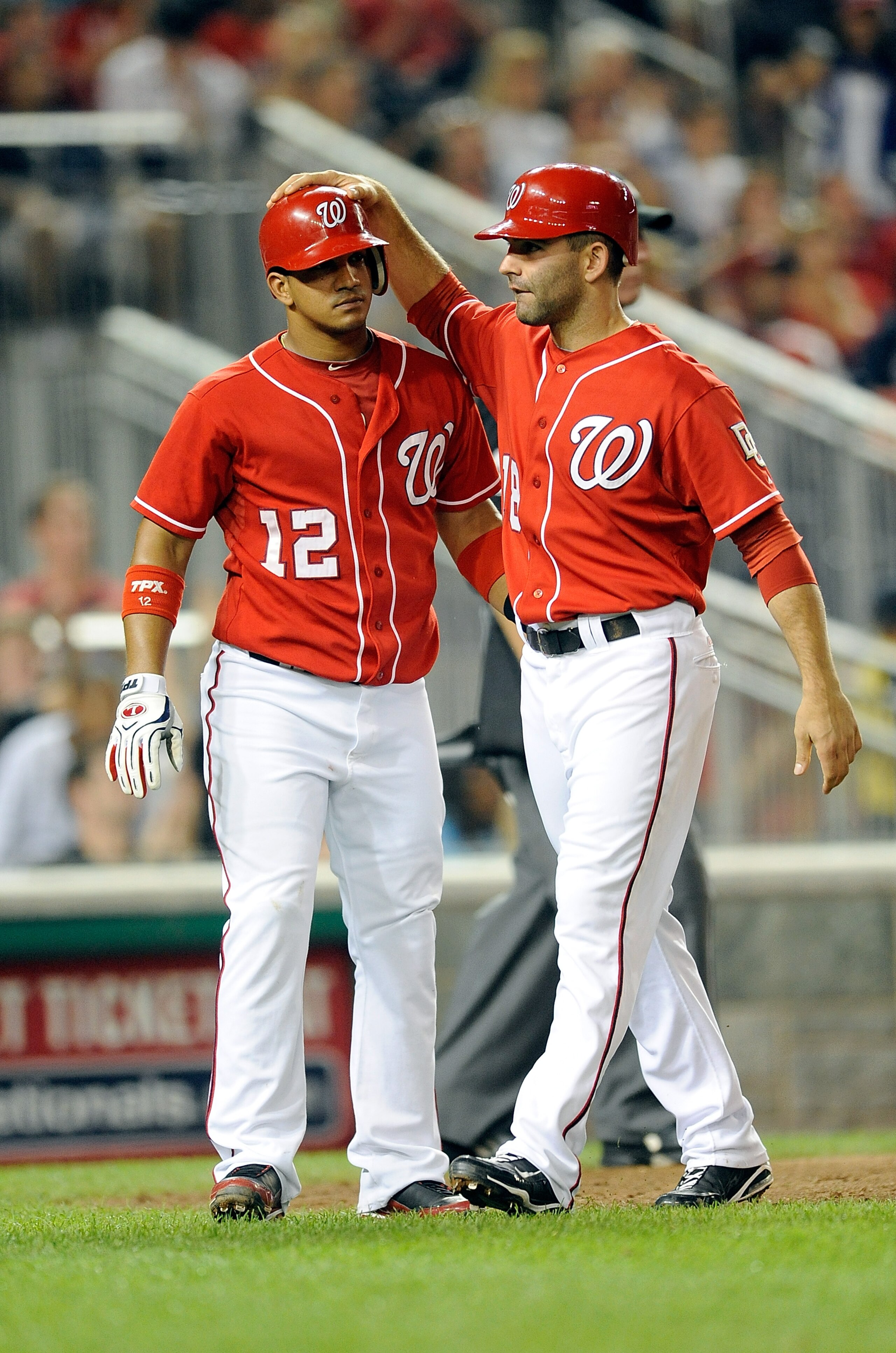 WASHINGTON - SEPTEMBER 24:  Alberto Gonzalez #12 and Danny Espinosa #18 of the Washington Nationals celebrate after scoring in the sixth inning against the Atlanta Braves at Nationals Park on September 24, 2010 in Washington, DC.  (Photo by Greg Fiume/Get