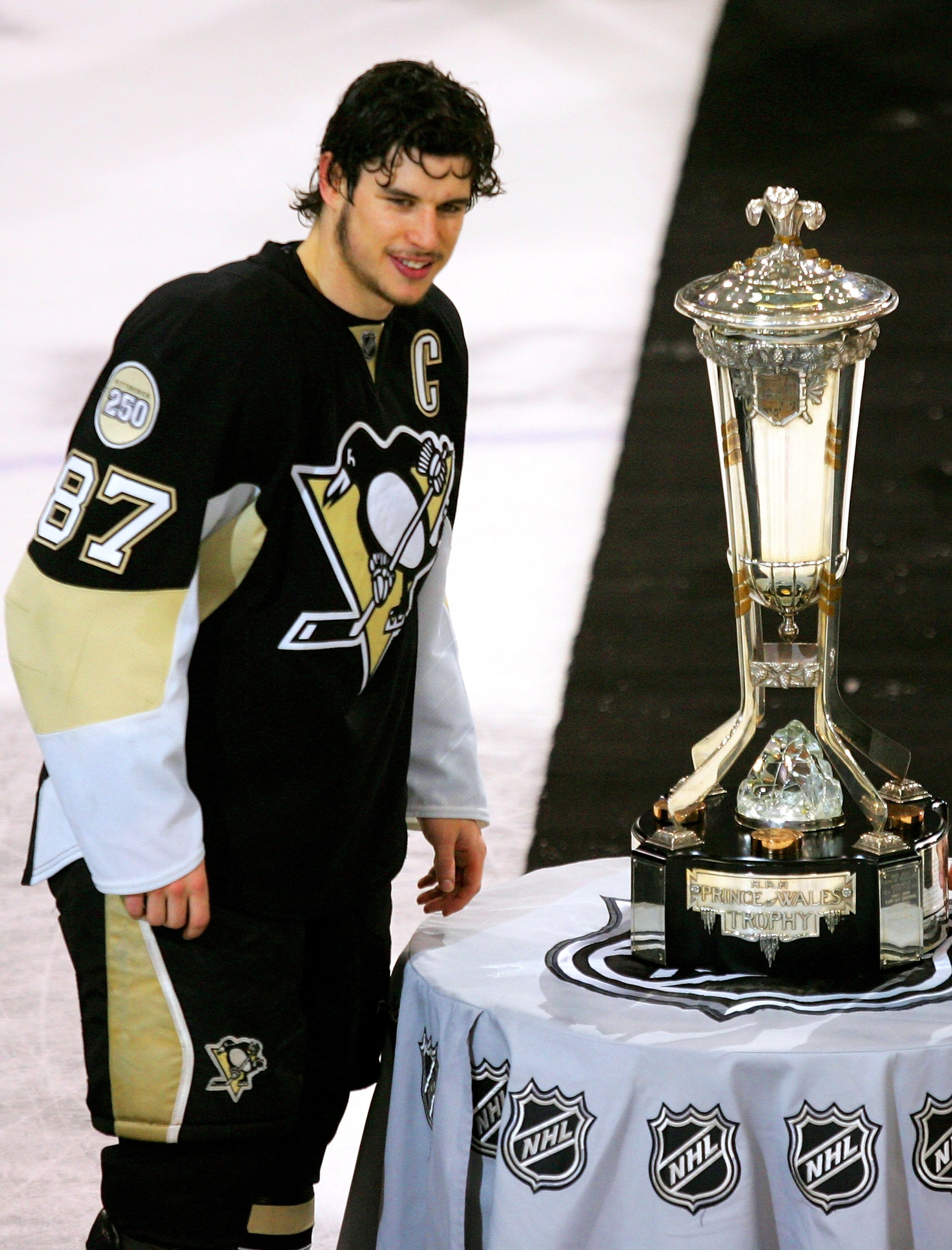 PITTSBURGH - MAY 18:  Sidney Crosby #87 of the Pittsburgh Penguins stands next to the Prince of Wales Trophy after his team's 6-0 victory over the Philadelphia Flyers in game five of the Eastern Conference Finals of the 2008 NHL Stanley Cup Playoffs at Me