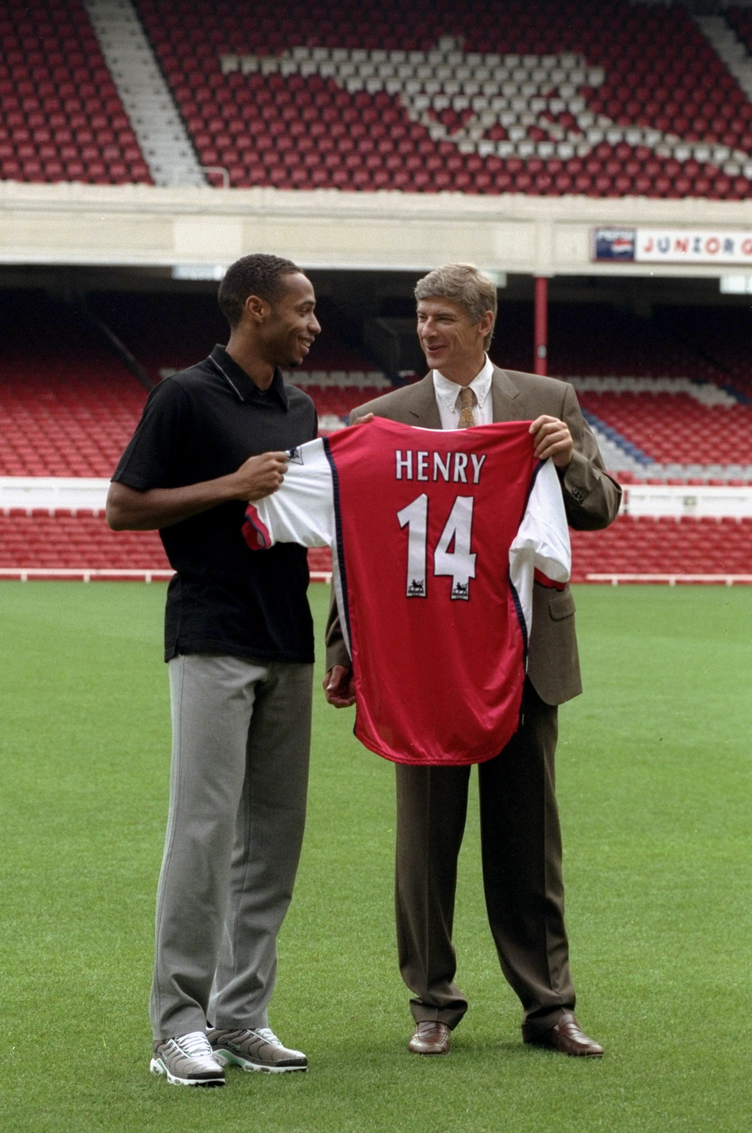 3 Aug 1999:  Thierry Henry signs for Arsenal Football Club and is presented to the media by his new manager Arsene Wenger during a photo-call held at Highbury in London, England. \ Mandatory Credit: John Gichigi /Allsport