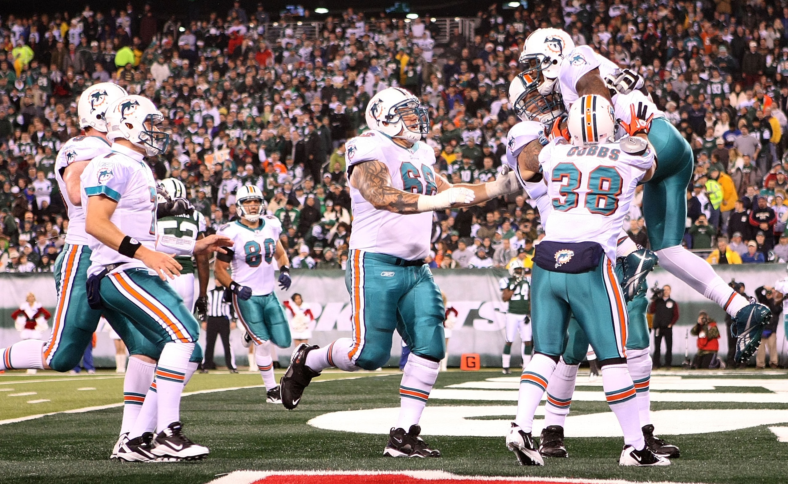 EAST RUTHERFORD, NJ - DECEMBER 12: The Miami Dolphins celebrate the touchdown of Brandon Marshall #19 against the New York Jets at New Meadowlands Stadium on December 12, 2010 in East Rutherford, New Jersey.  (Photo by Nick Laham/Getty Images)